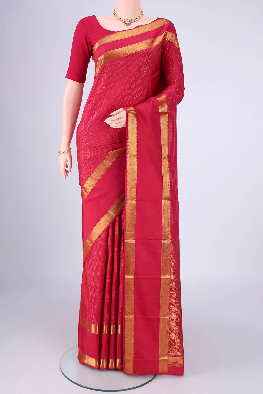 Dark Pink Kanjivaram Silk Saree with Checked design on the body and Zari Border.  displayed on a mannequin