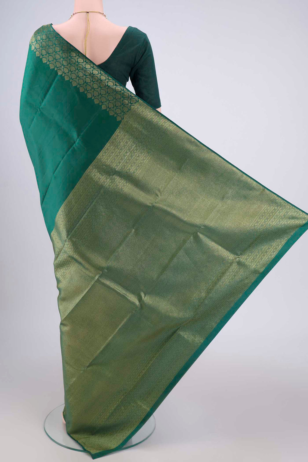Flat view of Bottle Green Kanjivaram Silk Saree with Plain Body and Zari Border. 