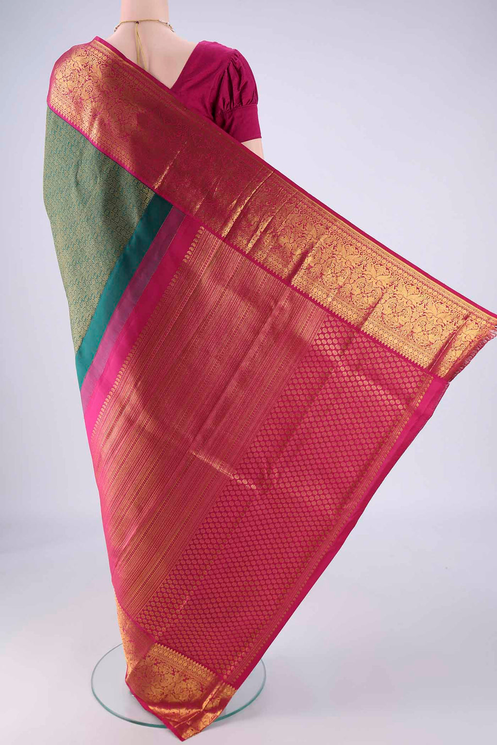 Flat view of Bottle Green Kanjivaram Silk Saree with Zari Brocade on the body and Zari Border. 