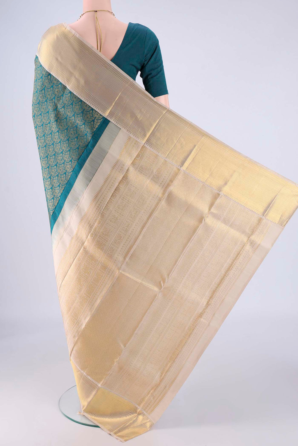 Flat view of Teal Kanjivaram Silk Saree with Zari Brocade on the body and Zari Border. 
