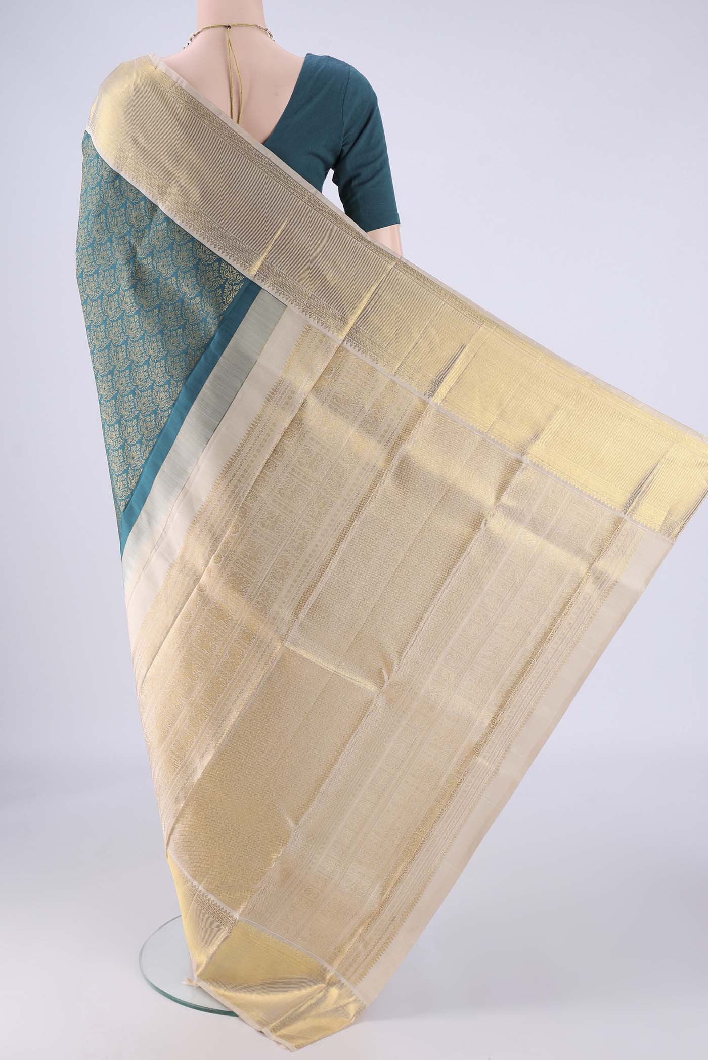 Flat view of Teal Kanjivaram Silk Saree with Zari Brocade on the body and Zari Border. 