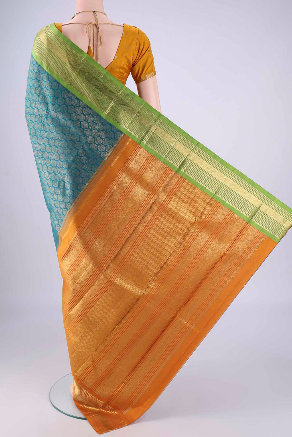 Flat view of Pure Silk Pure Zari Teal Kanjivaram Saree with Zari Brocade on the body and Ganga Jamuna Border. 