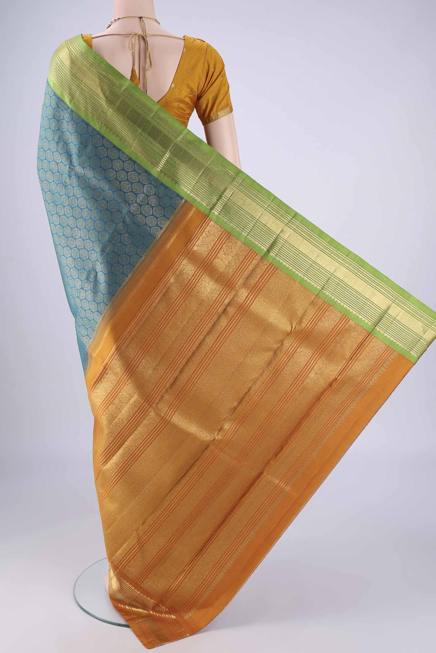 Flat view of Pure Silk Pure Zari Teal Kanjivaram Saree with Zari Brocade on the body and Ganga Jamuna Border. 