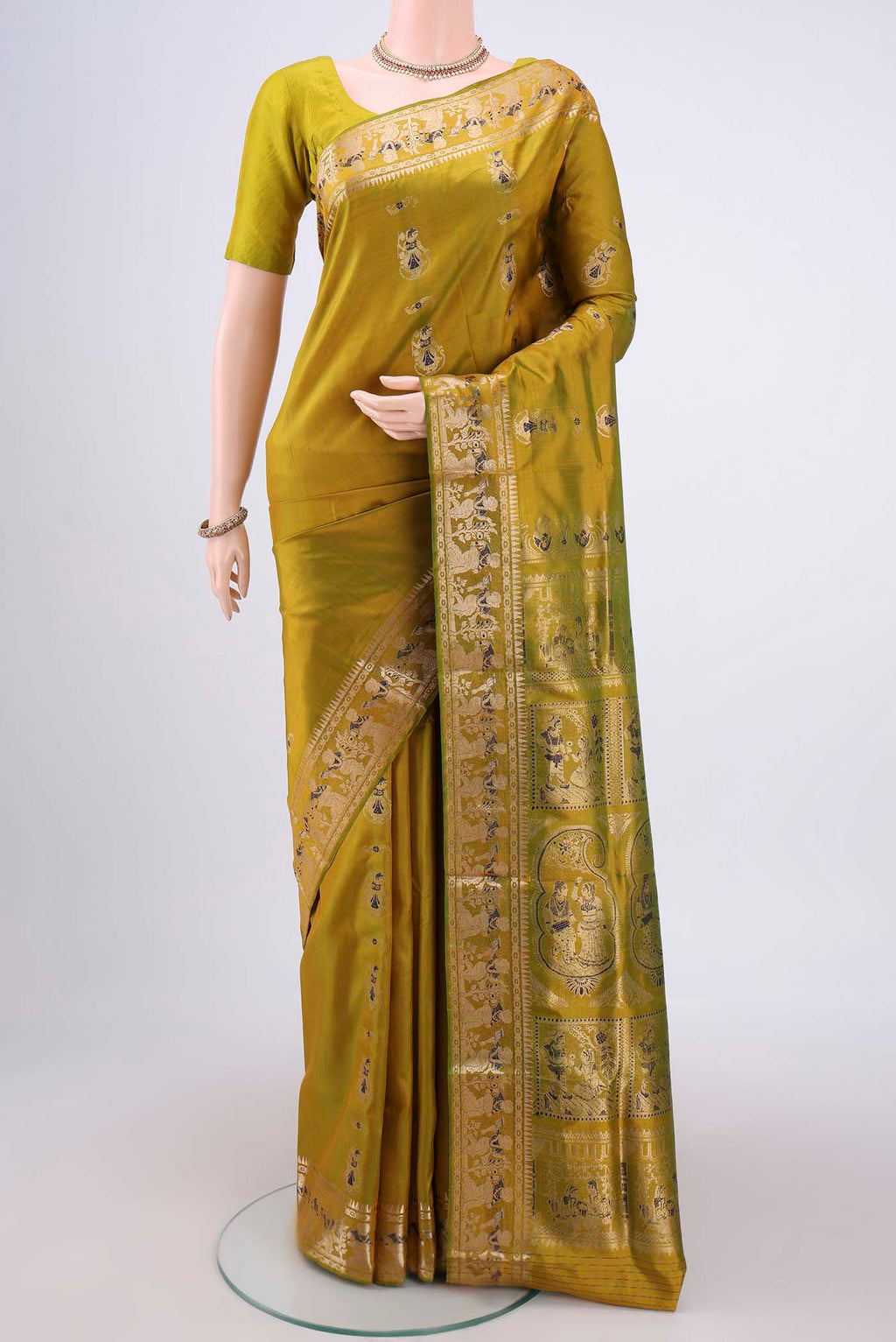 Acid Green Baluchari Silk Saree with Zari And Thread Butta on the body and Zari And Thread Border.  displayed on a mannequin