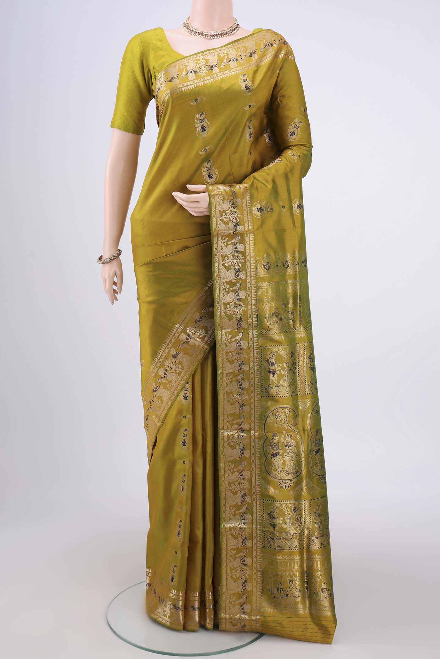 Acid Green Baluchari Silk Saree with Zari And Thread Butta on the body and Zari And Thread Border.  displayed on a mannequin