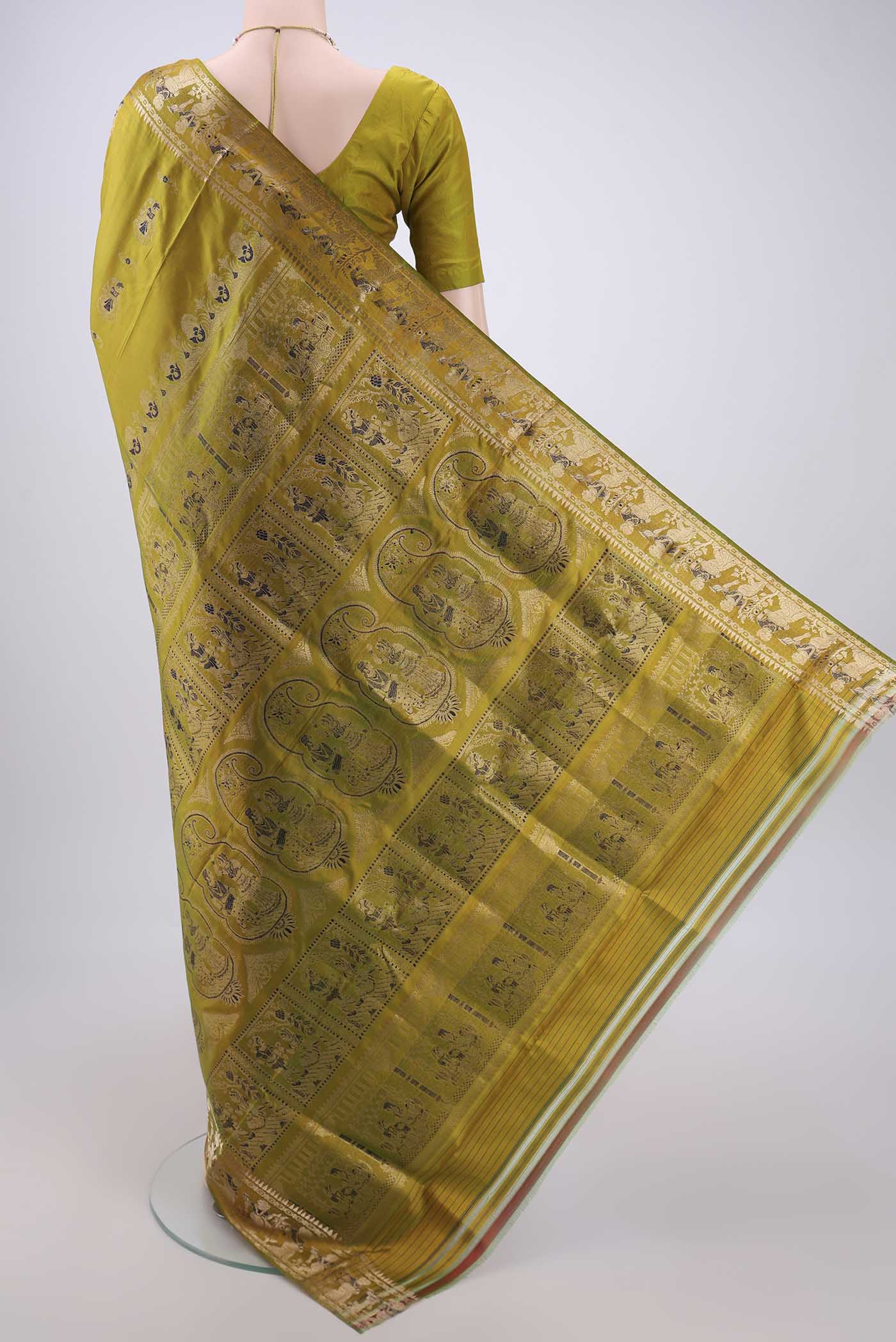 Flat view of Acid Green Baluchari Silk Saree with Zari And Thread Butta on the body and Zari And Thread Border. 