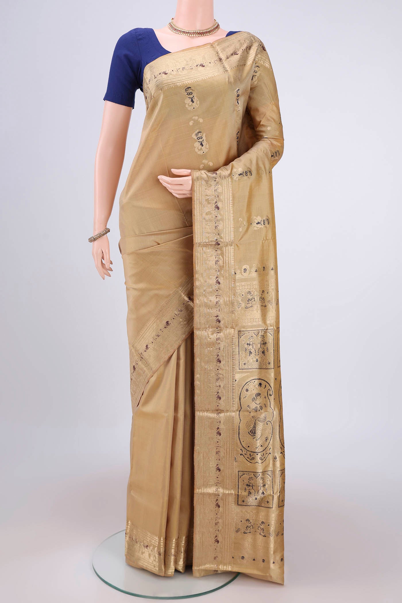 Beige Baluchari Silk Saree with Zari And Thread Butta on the body and Zari And Thread Border.  displayed on a mannequin