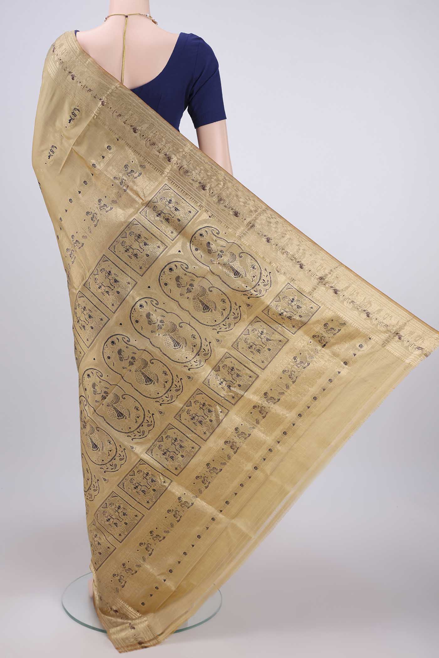 Flat view of Beige Baluchari Silk Saree with Zari And Thread Butta on the body and Zari And Thread Border. 