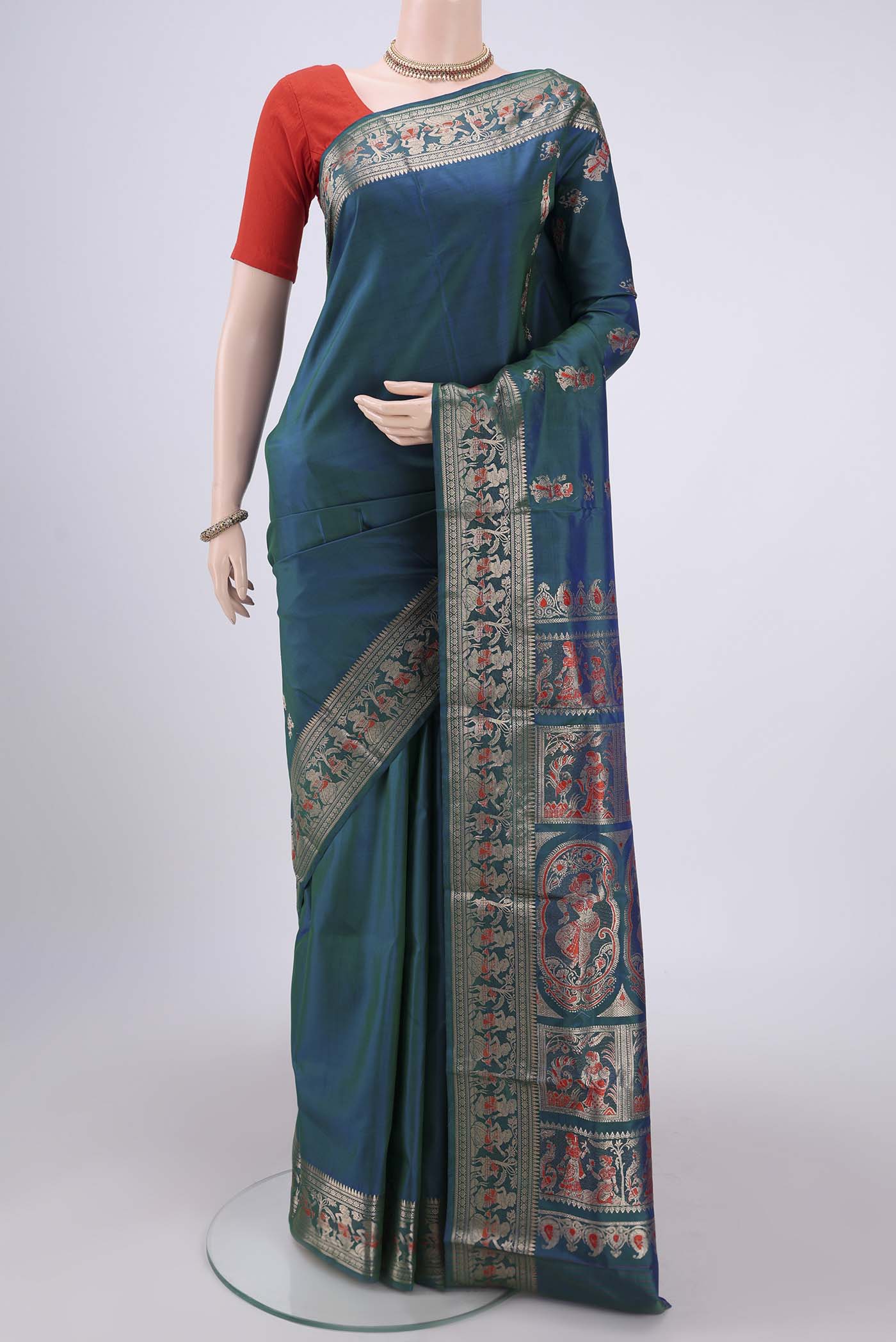Peacock Blue Baluchari Silk Saree with Zari And Thread Butta on the body and Zari And Thread Border.  displayed on a mannequin
