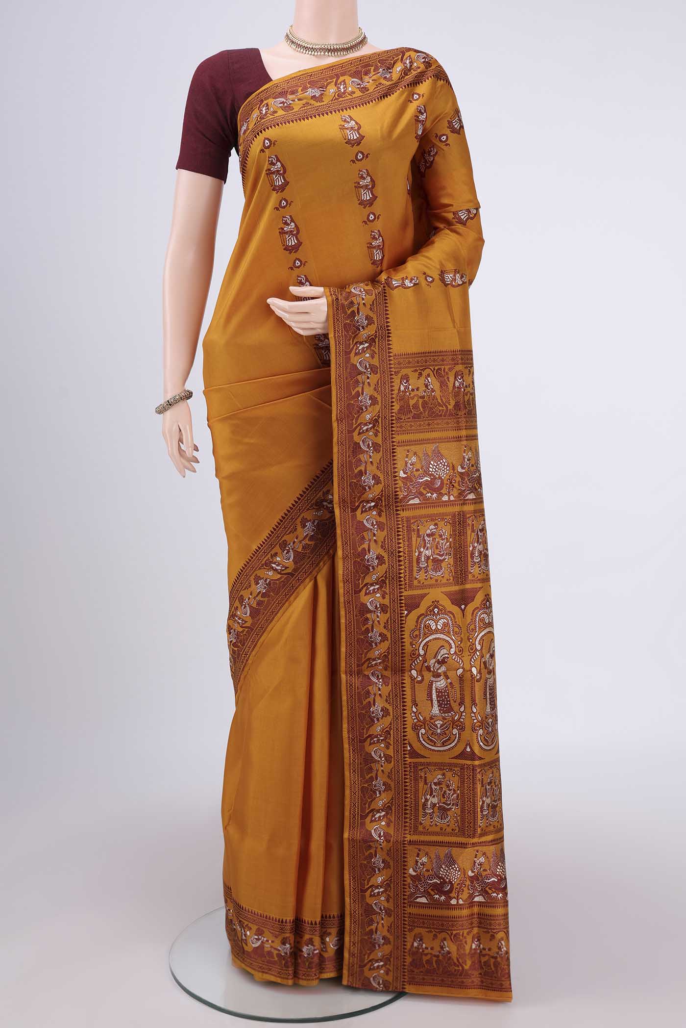 Mustard Baluchari Silk Saree with Thread Butta on the body and Thread Border.  displayed on a mannequin