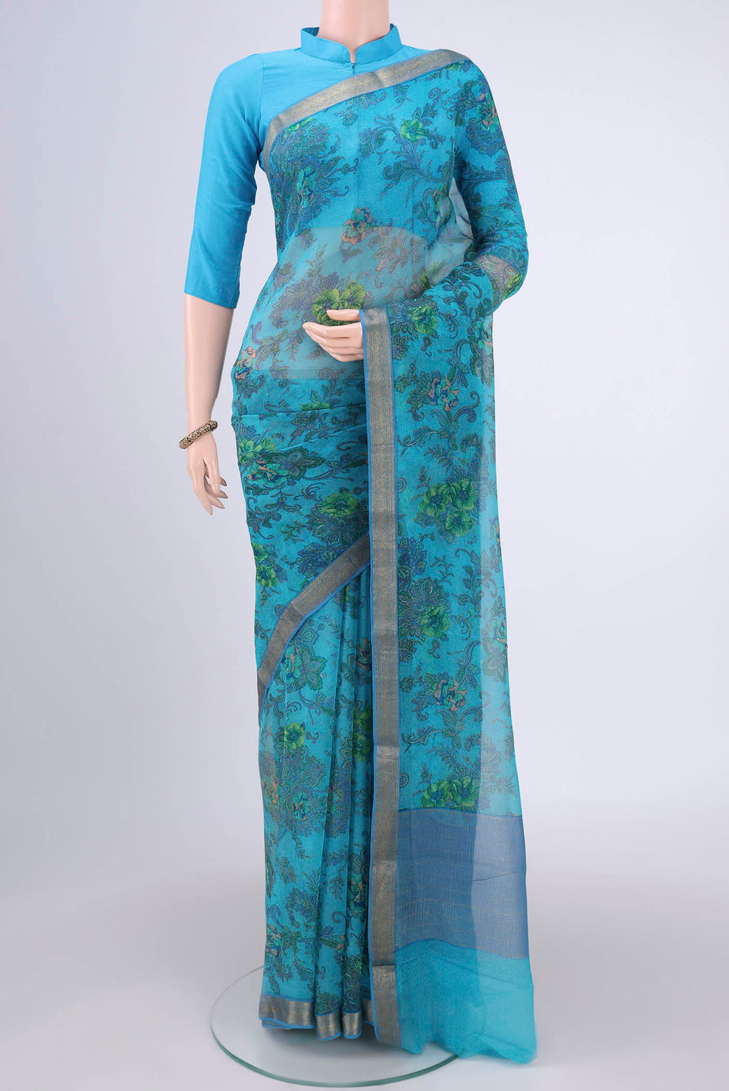 Blue Mysore Chiffon Saree with Floral Print on the body and Zari Border.  displayed on a mannequin