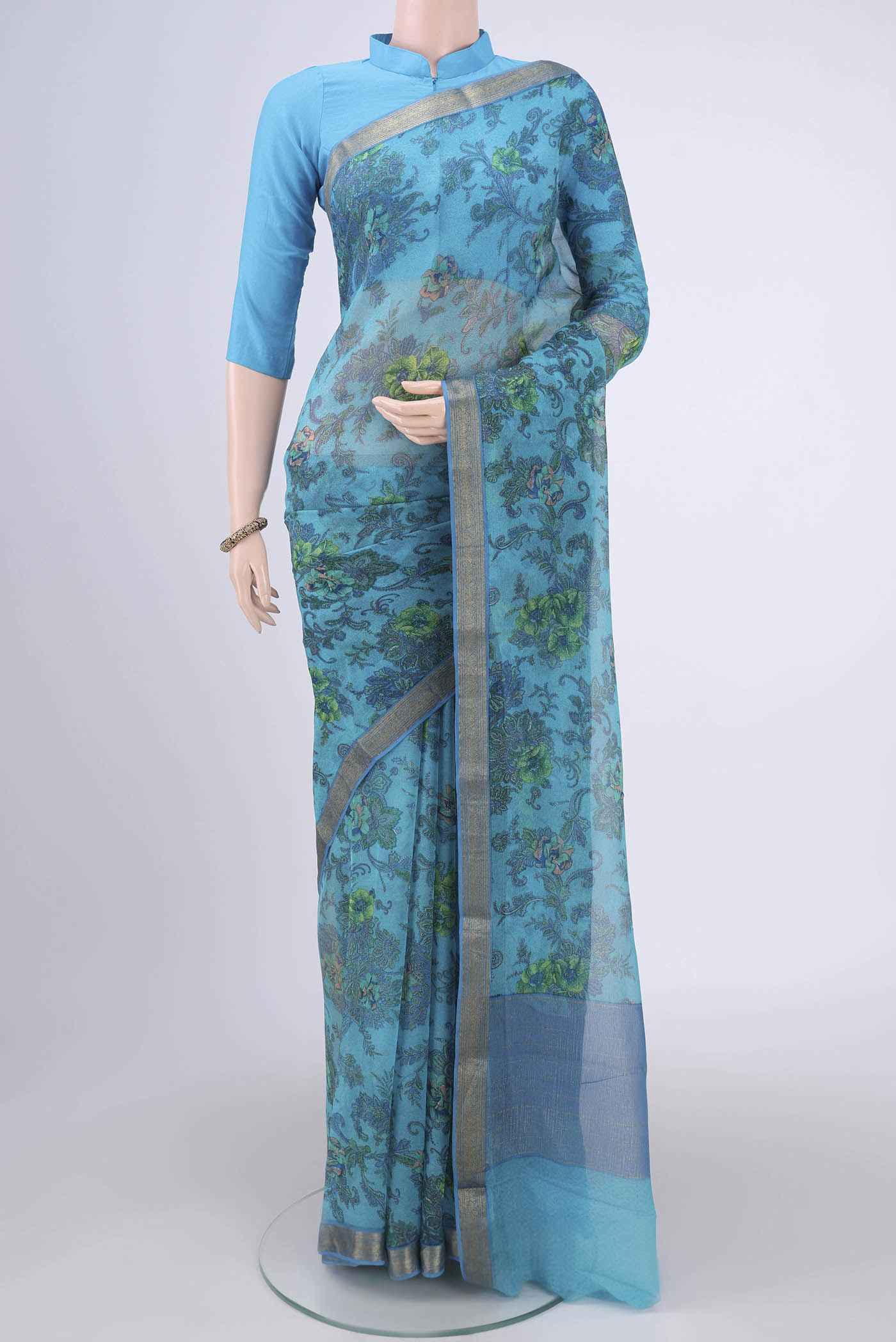 Blue Mysore Chiffon Saree with Floral Print on the body and Zari Border.  displayed on a mannequin