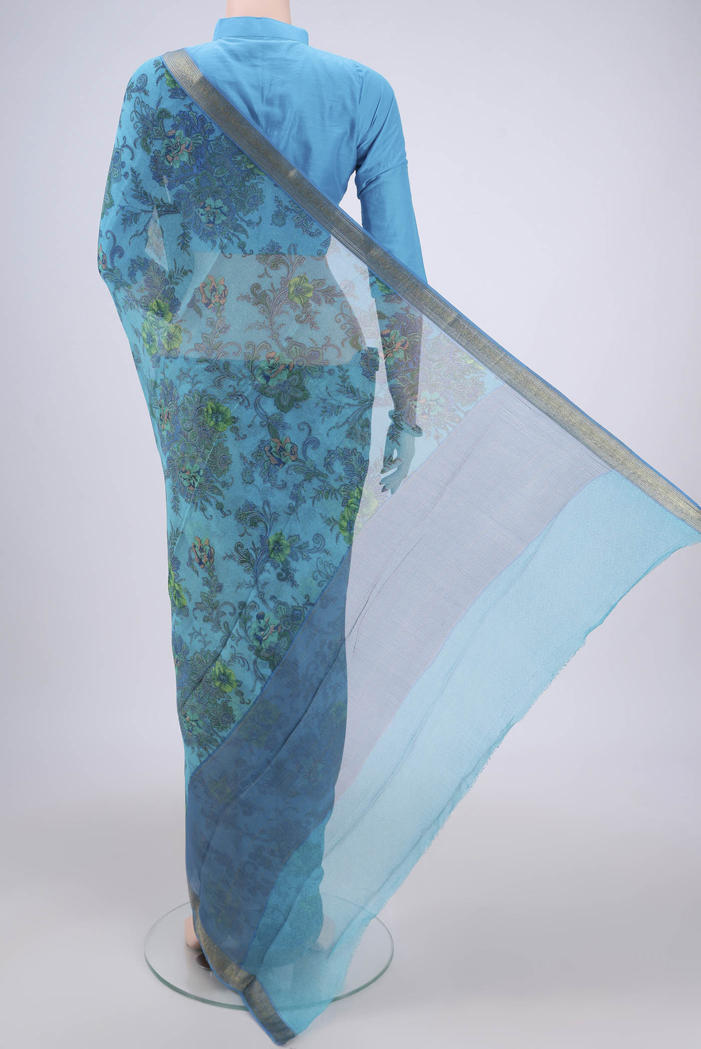 Flat view of Blue Mysore Chiffon Saree with Floral Print on the body and Zari Border. 