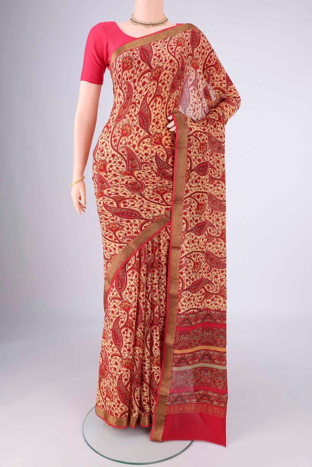 Sandal Mysore Crepe Saree with Printed design on the body and Zari Border.  displayed on a mannequin