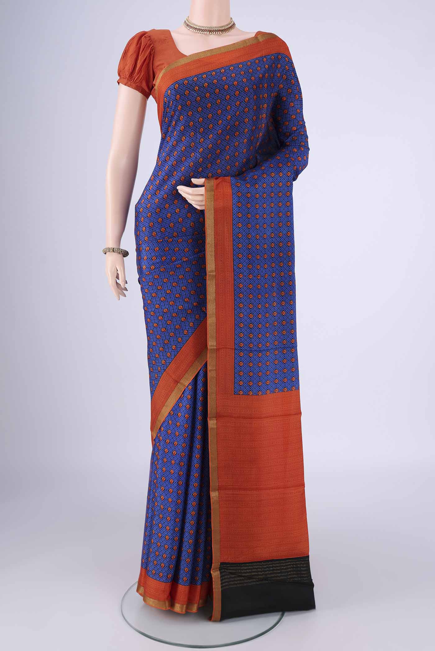 Royal Blue Mysore Crepe Saree with Printed design on the body and Printed Border.  displayed on a mannequin