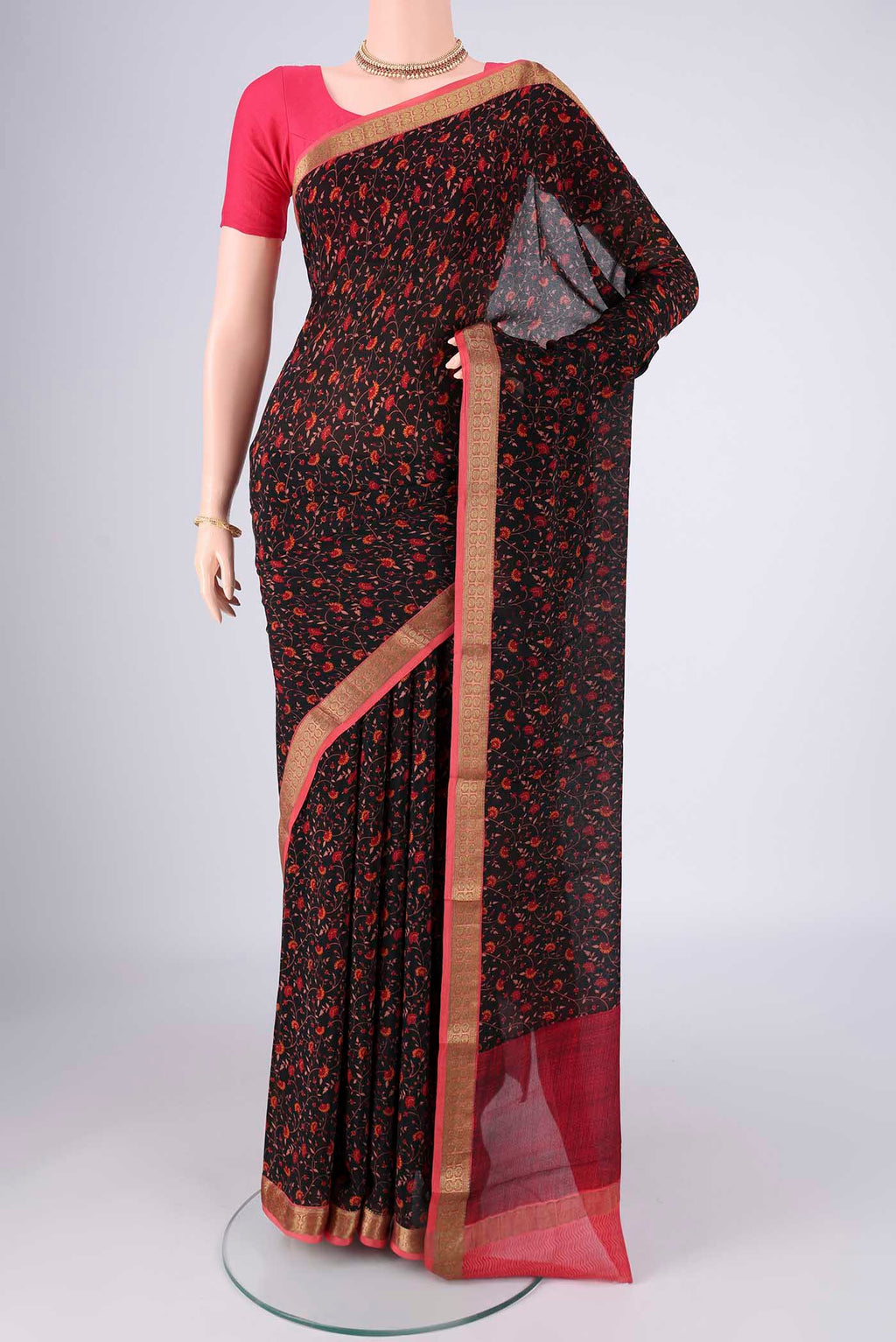 Black Mysore Crepe Saree with Printed design on the body and Zari Border.  displayed on a mannequin