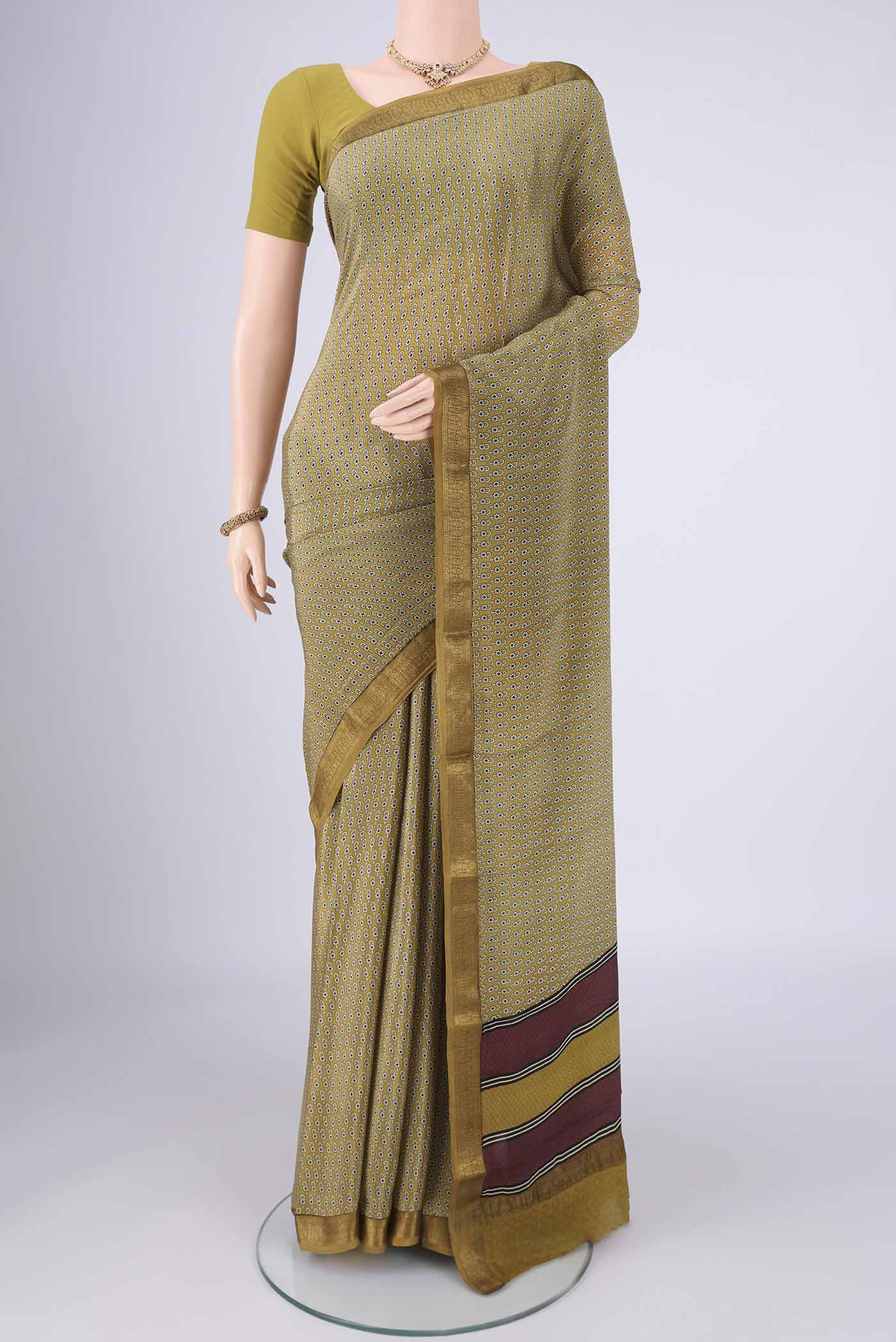 Mehandi Green Mysore Crepe Saree with Printed design on the body and Zari Border.  displayed on a mannequin