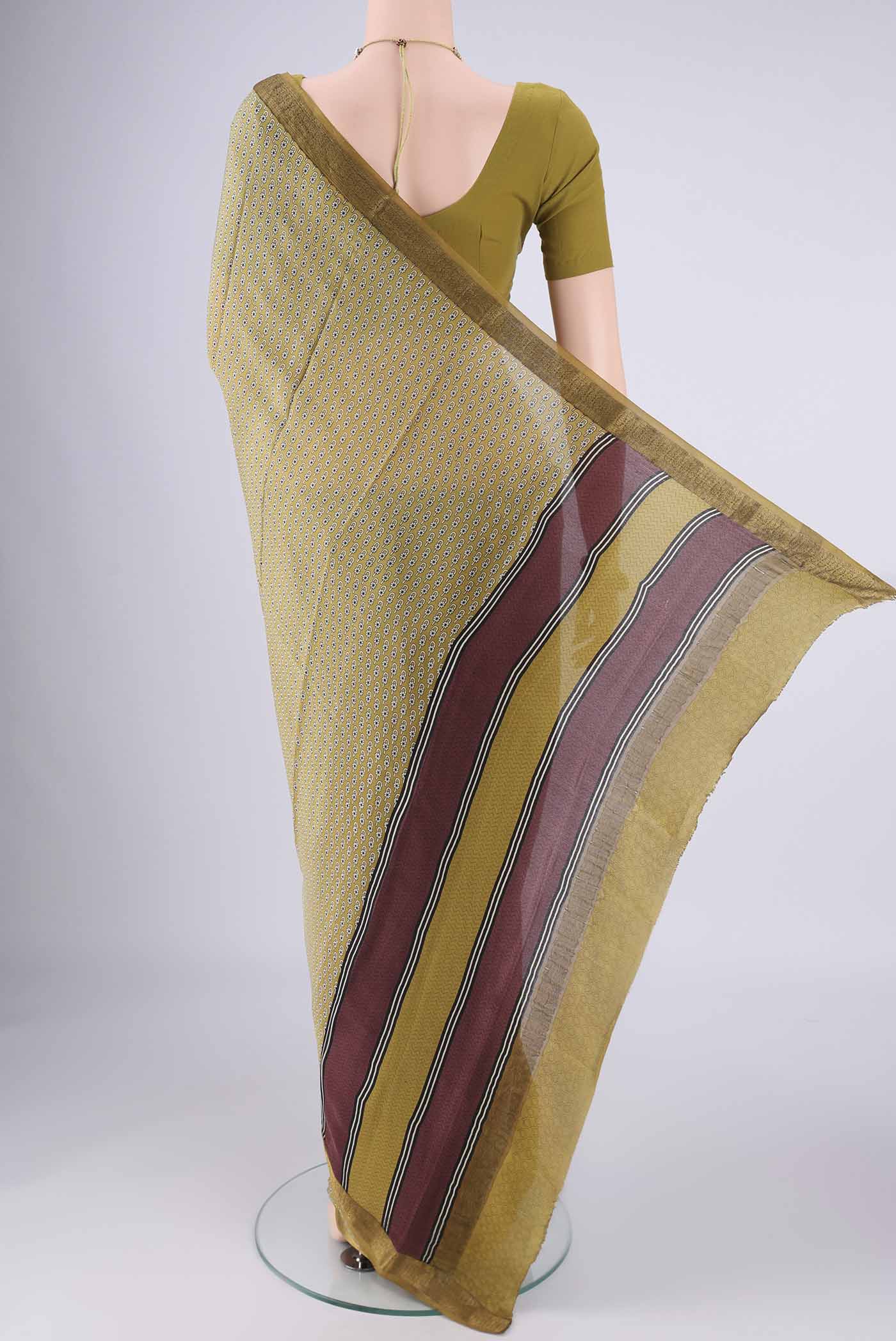 Flat view of Mehandi Green Mysore Crepe Saree with Printed design on the body and Zari Border. 
