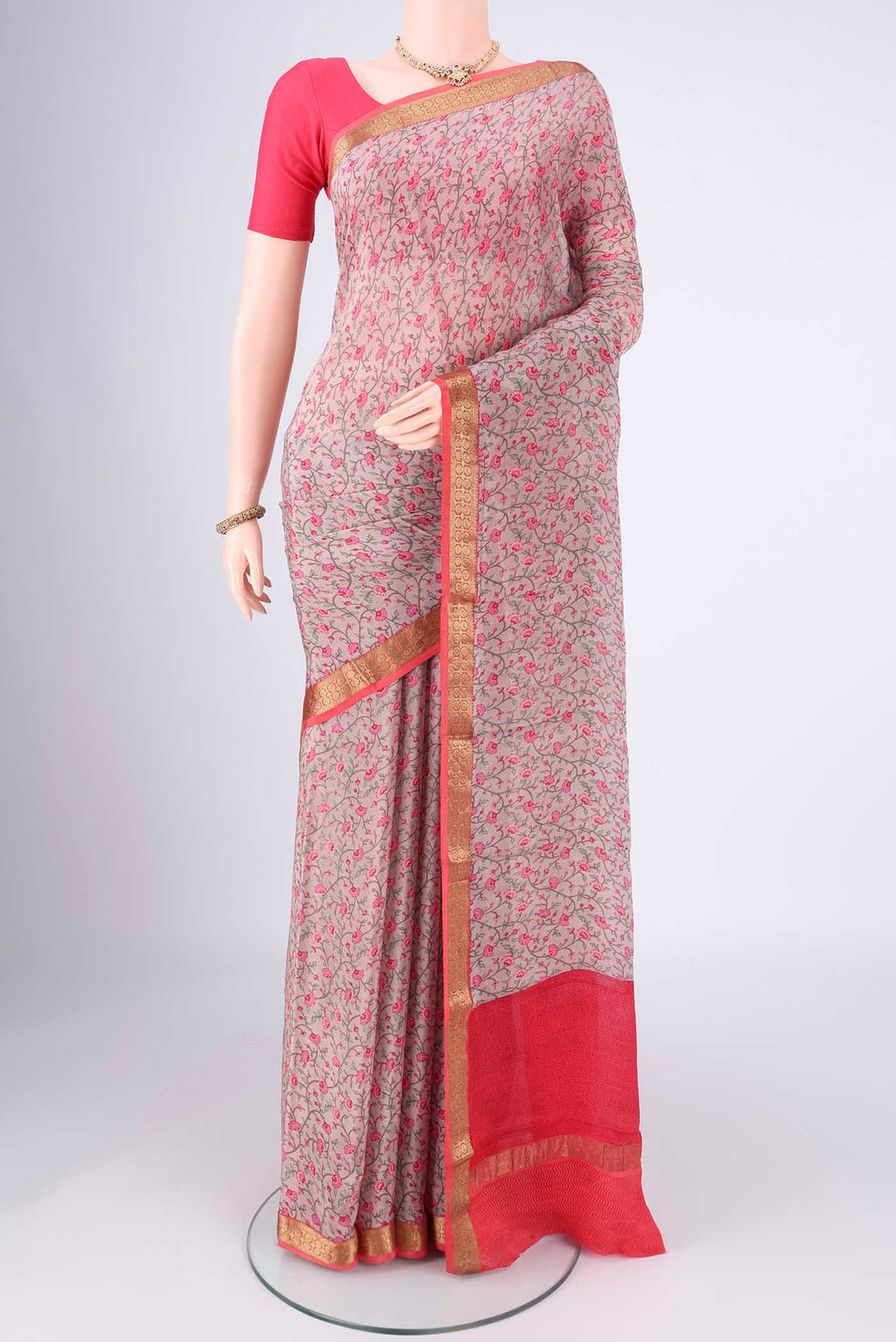 Grey Mysore Crepe Saree with Printed design on the body and Zari Border.  displayed on a mannequin