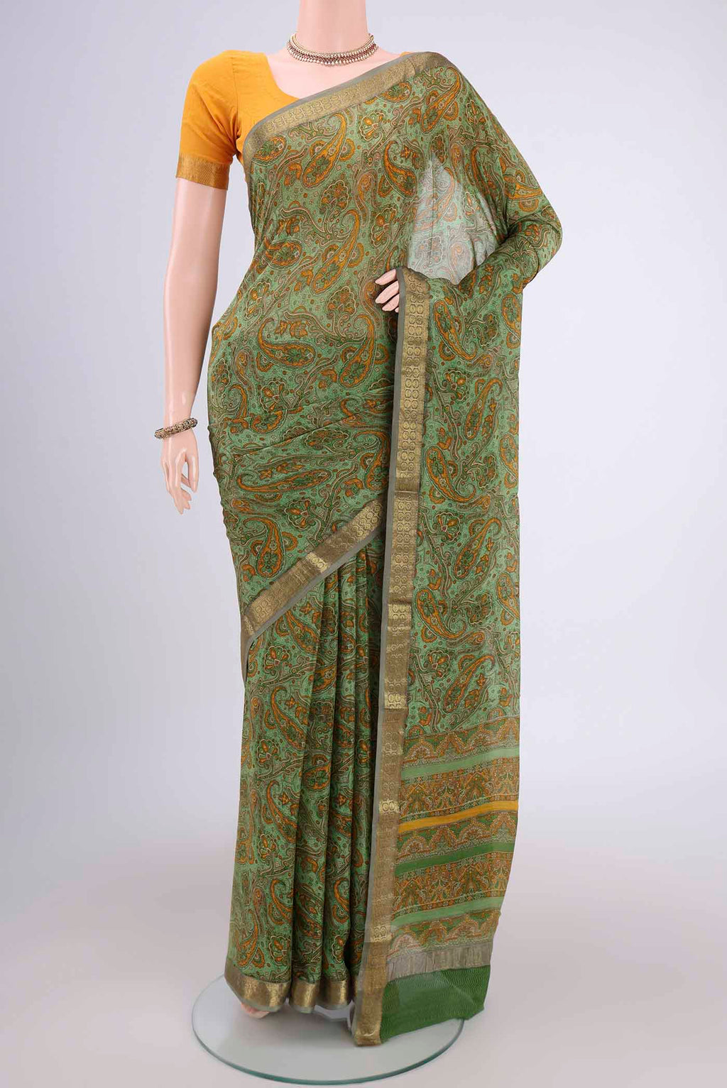 Light Green Mysore Crepe Saree with Floral Print on the body and Zari Border.  displayed on a mannequin
