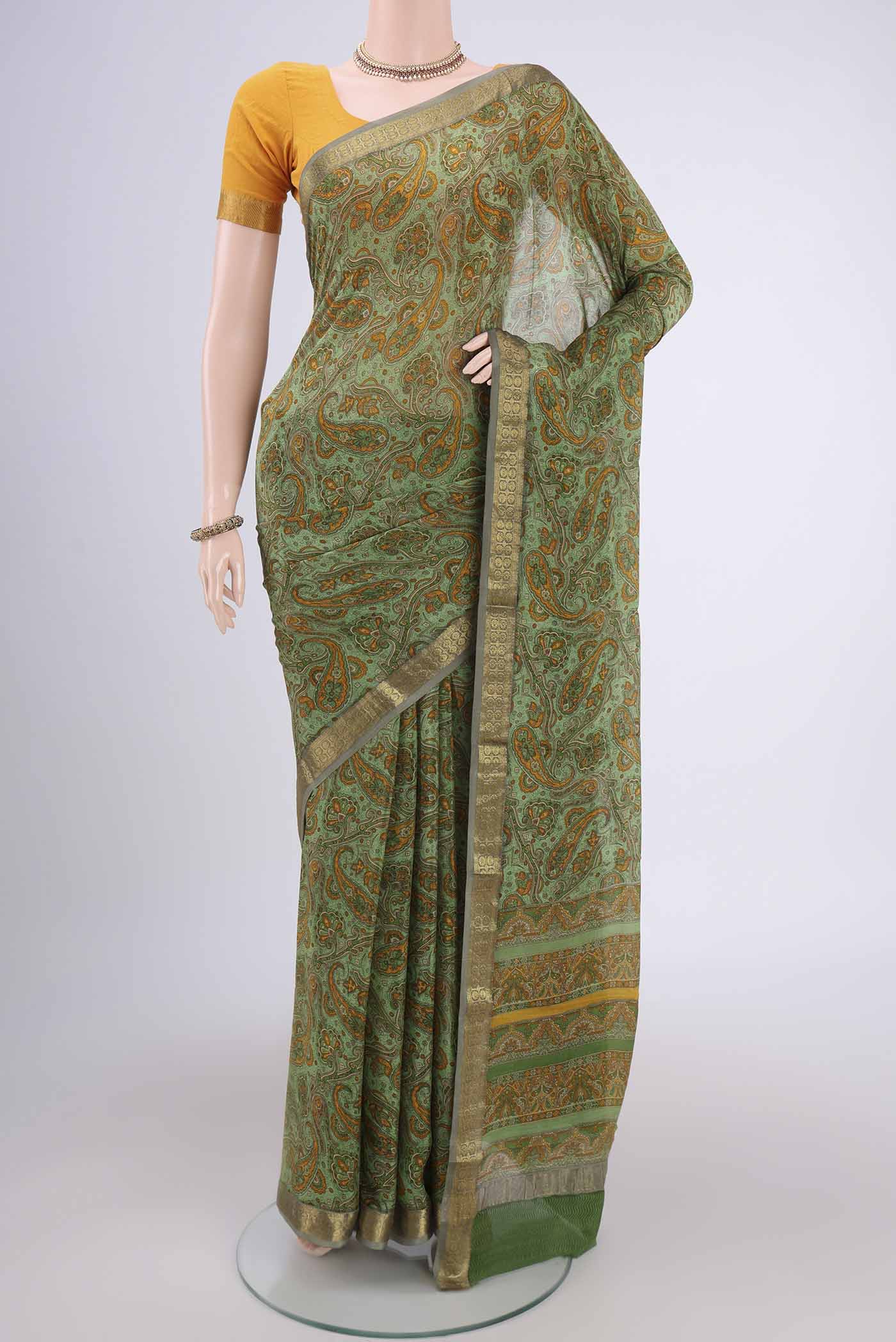 Light Green Mysore Crepe Saree with Floral Print on the body and Zari Border.  displayed on a mannequin