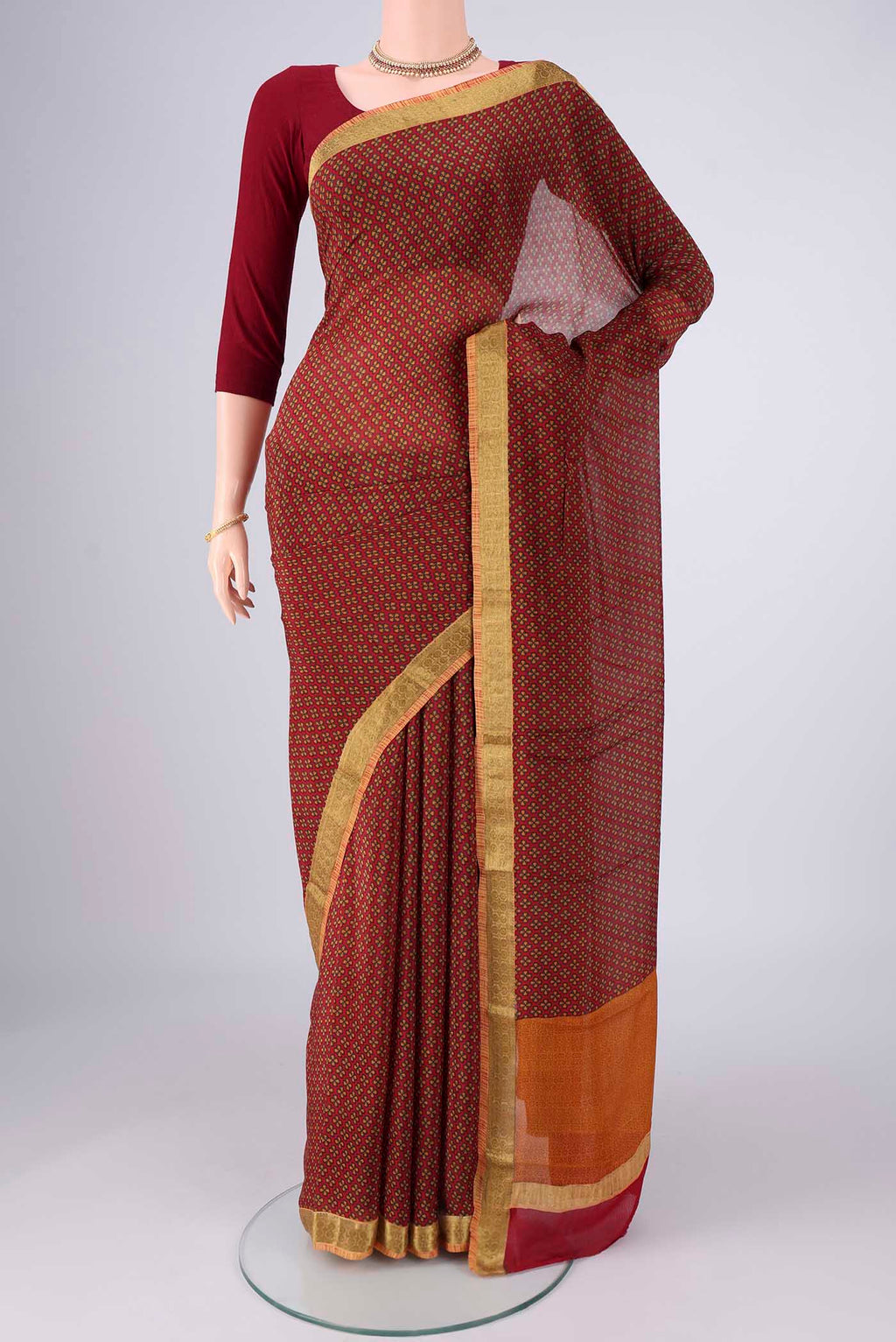 Maroon Mysore Crepe Saree with Printed design on the body and Zari Border.  displayed on a mannequin