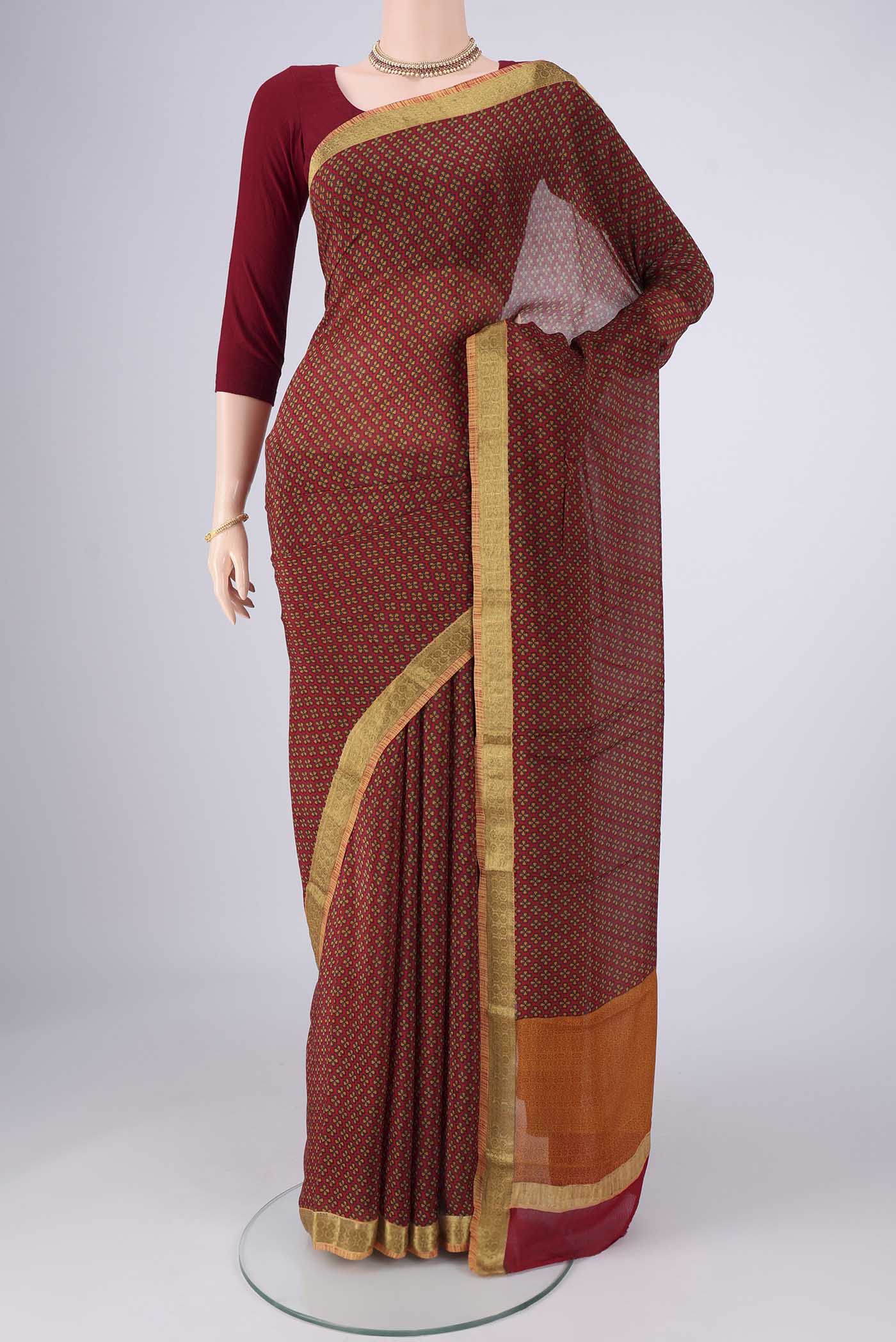 Maroon Mysore Crepe Saree with Printed design on the body and Zari Border.  displayed on a mannequin
