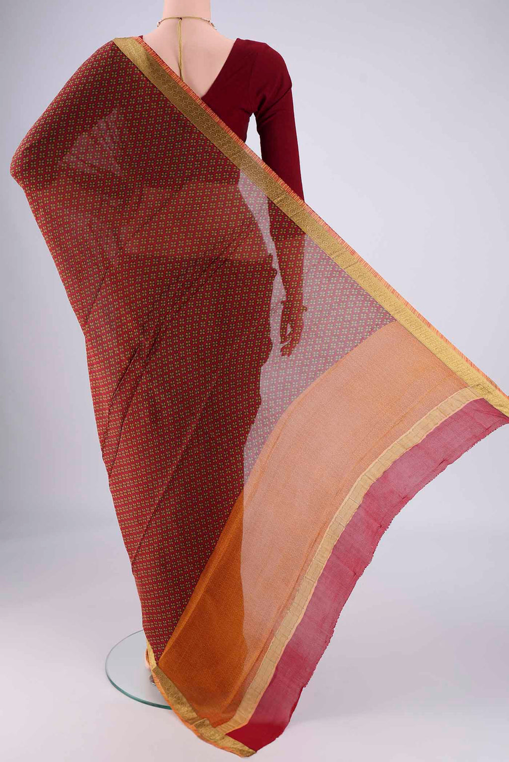 Flat view of Maroon Mysore Crepe Saree with Printed design on the body and Zari Border. 