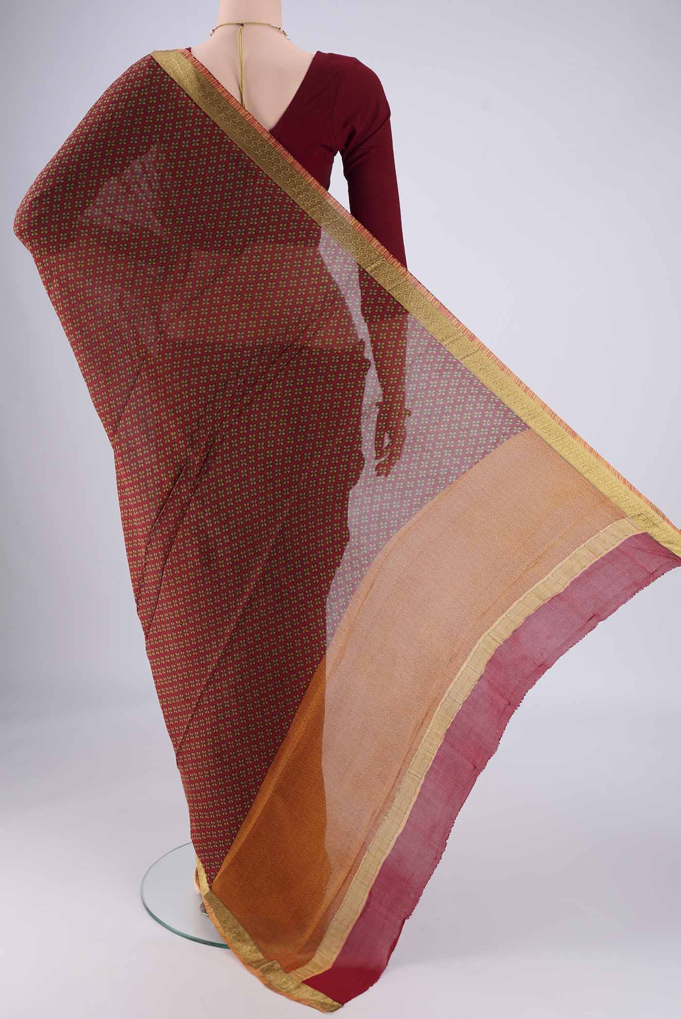 Flat view of Maroon Mysore Crepe Saree with Printed design on the body and Zari Border. 
