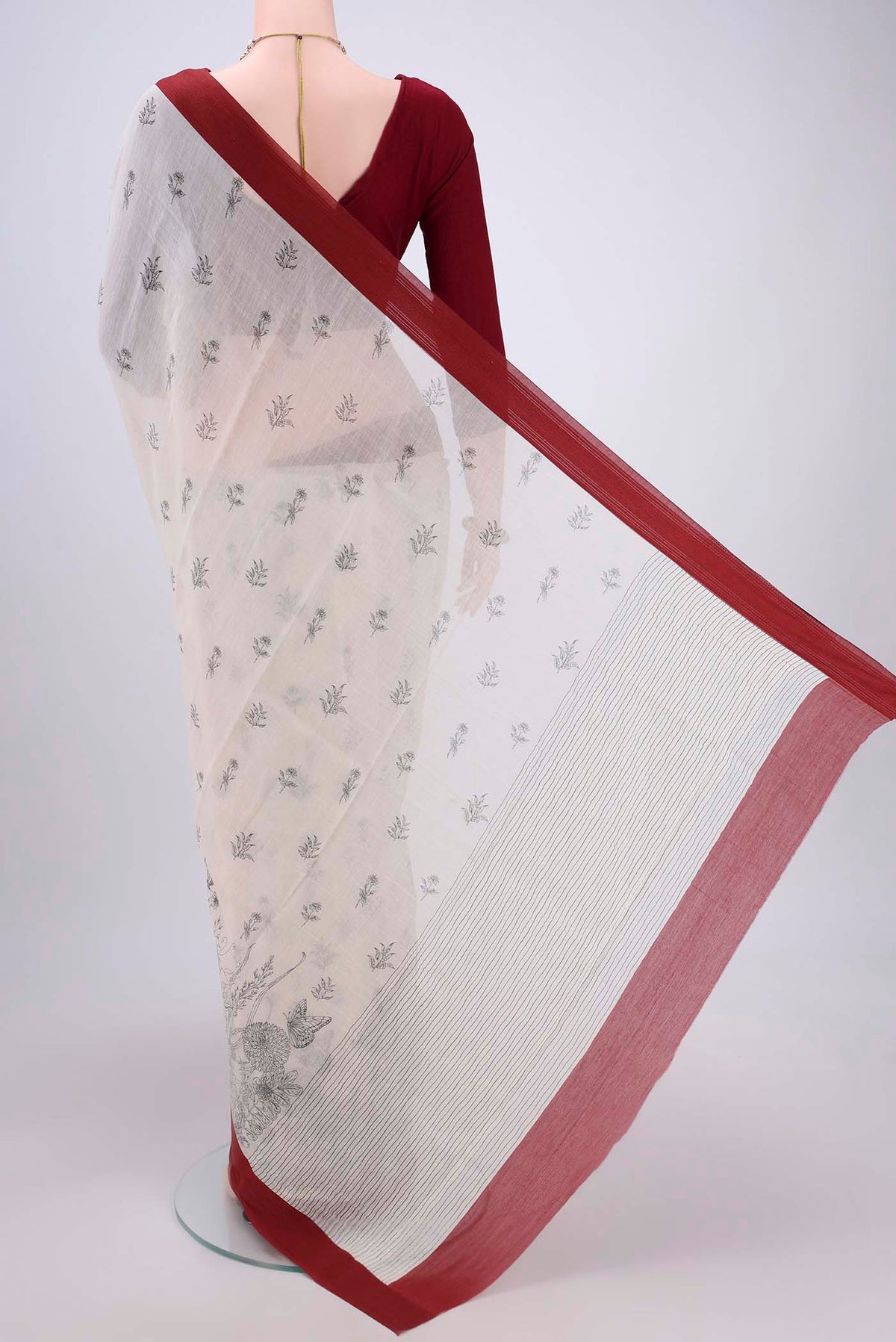 Flat view of White Silk Cotton Saree with Printed design on the body and Plain Border. 