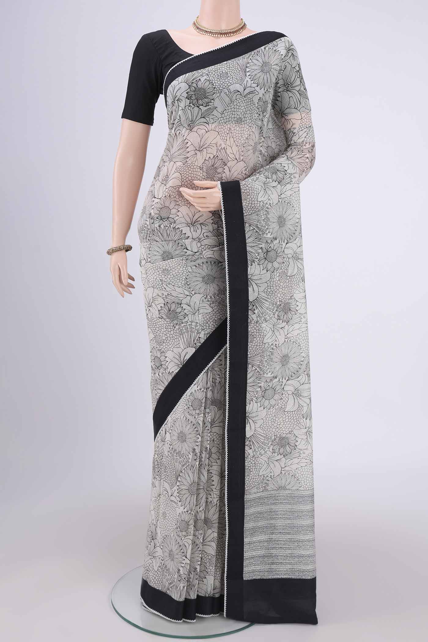 White Silk Cotton Saree with Printed design on the body and Plain Border.  displayed on a mannequin