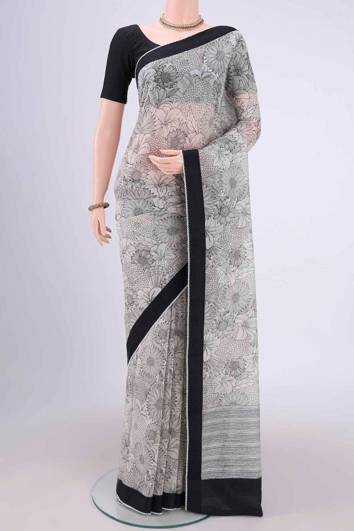 White Silk Cotton Saree with Printed design on the body and Plain Border.  displayed on a mannequin