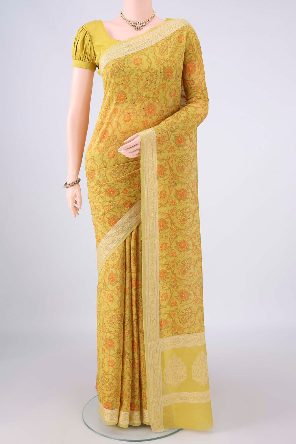 Yellow Chanderi Cotton Saree with Printed design on the body and Thread Border.  displayed on a mannequin