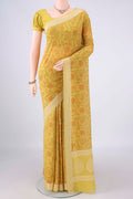 Yellow Chanderi Cotton Saree with Printed design on the body and Thread Border.  displayed on a mannequin