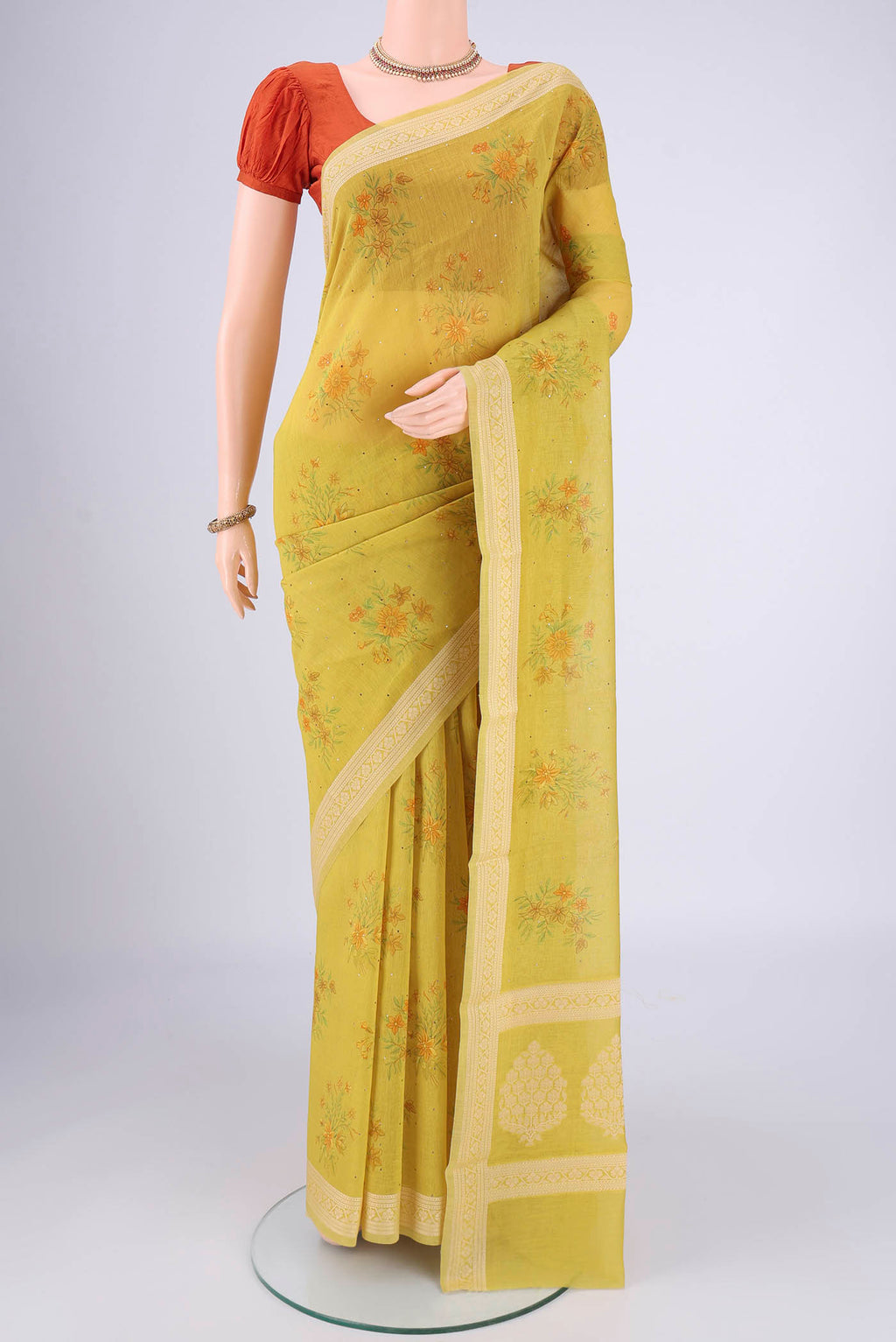 Acid Green Chanderi Silk Cotton Saree with Floral Print on the body and Zari Border.  displayed on a mannequin