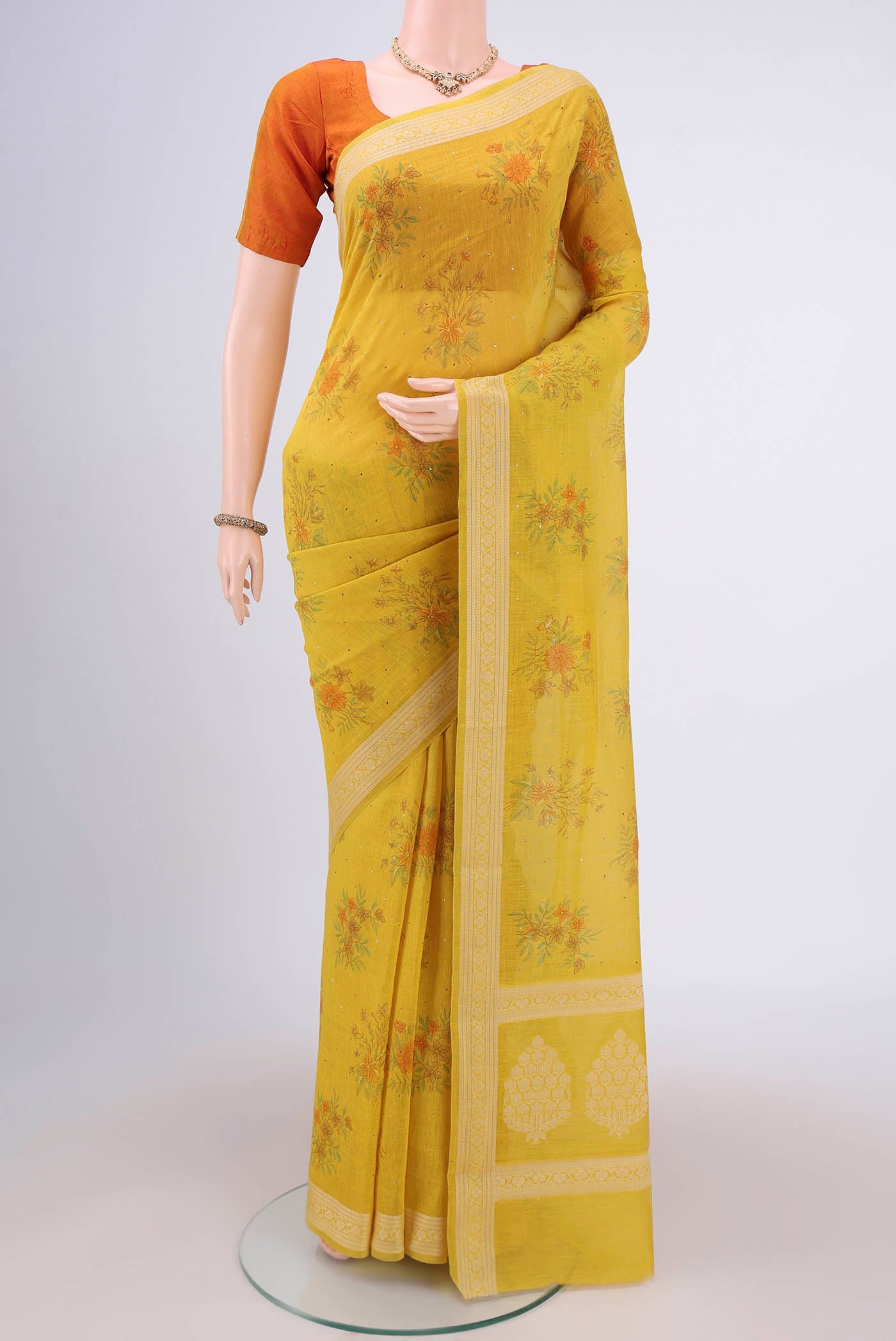 Yellow Chanderi Silk Saree with Printed design on the body and Thread Border.  displayed on a mannequin
