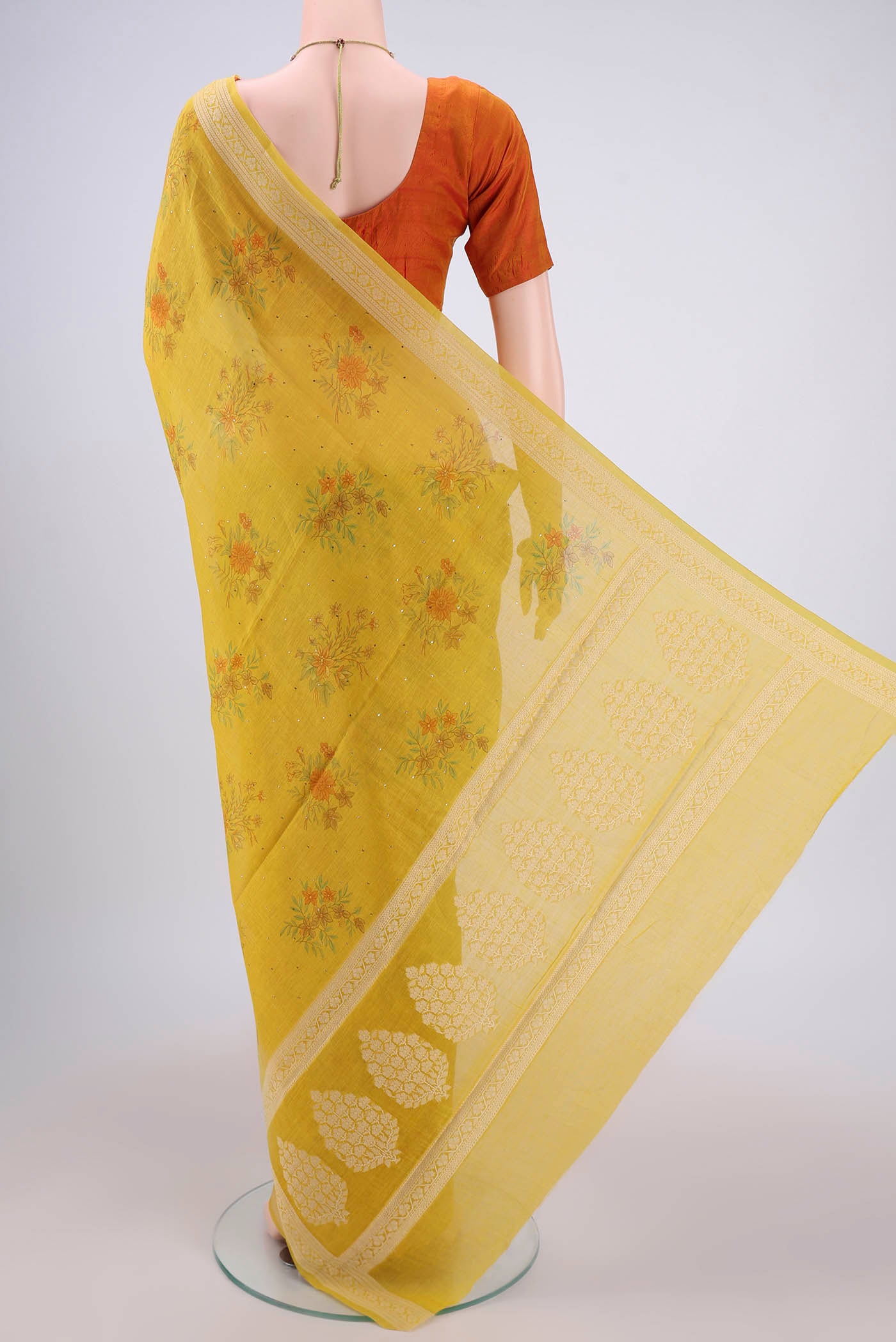 Flat view of Yellow Chanderi Silk Saree with Printed design on the body and Thread Border. 