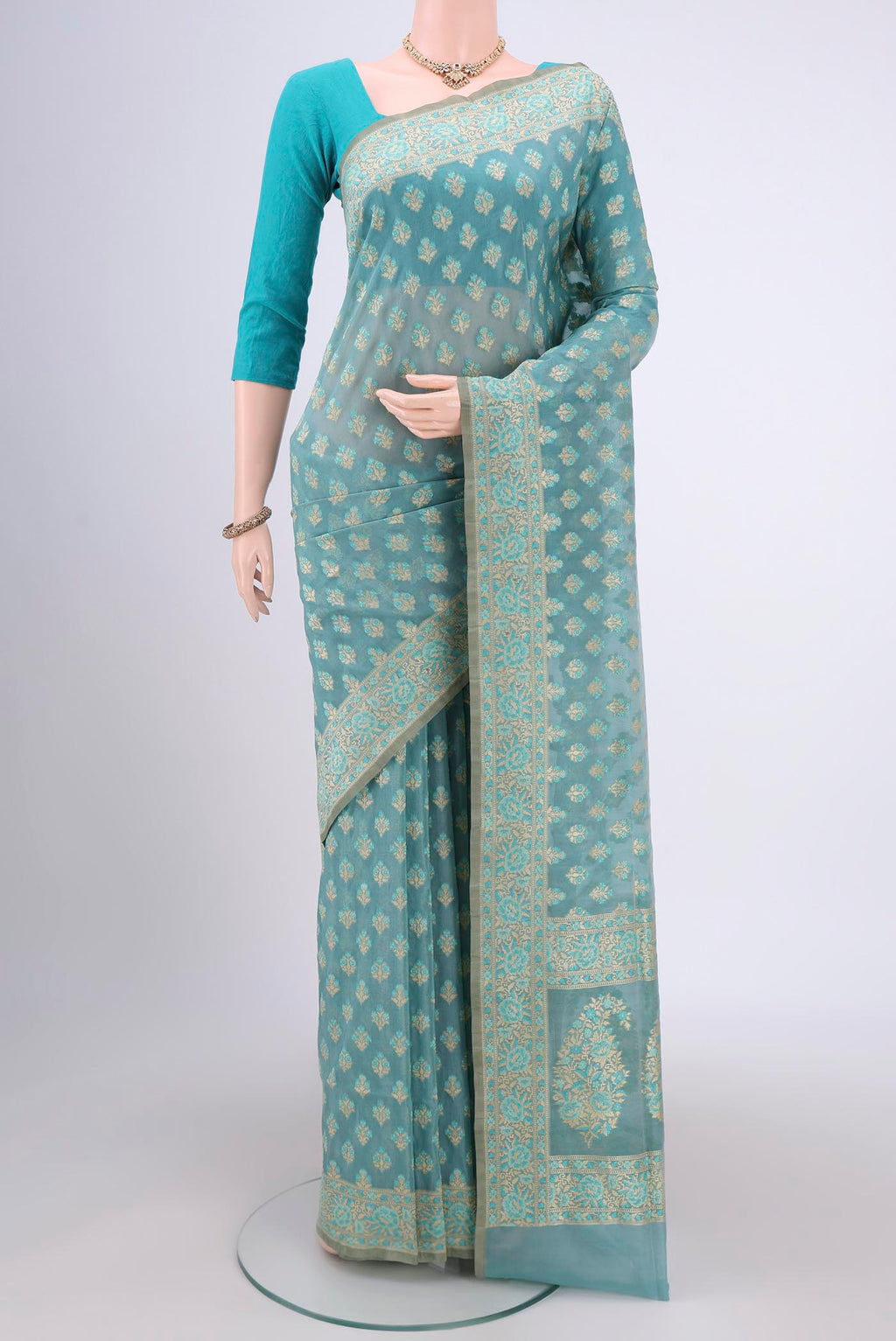 Sky Blue Banarasi Silk Saree with Zari And Thread Butta on the body and Zari Border.  displayed on a mannequin