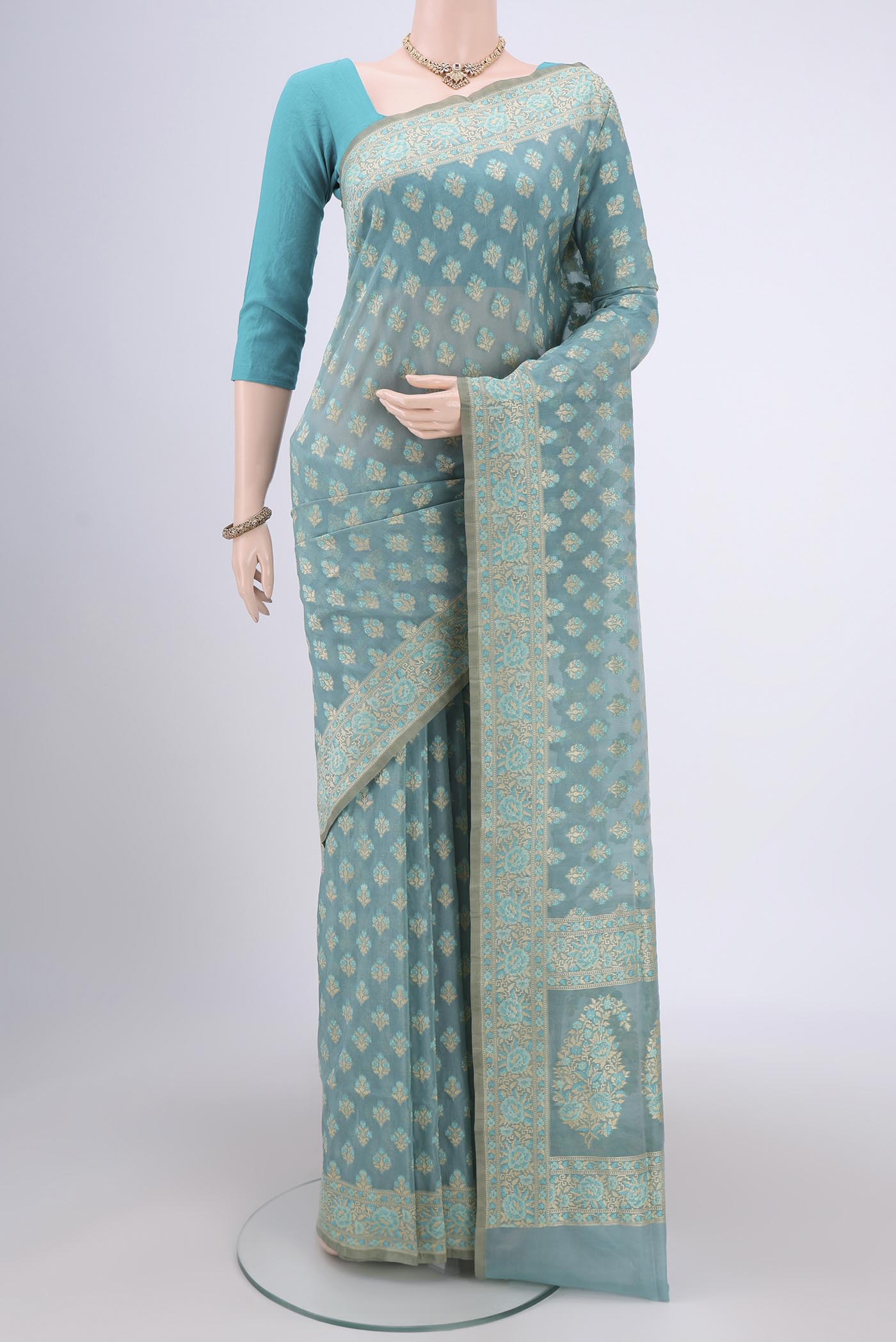Sky Blue Banarasi Silk Saree with Zari And Thread Butta on the body and Zari Border.  displayed on a mannequin