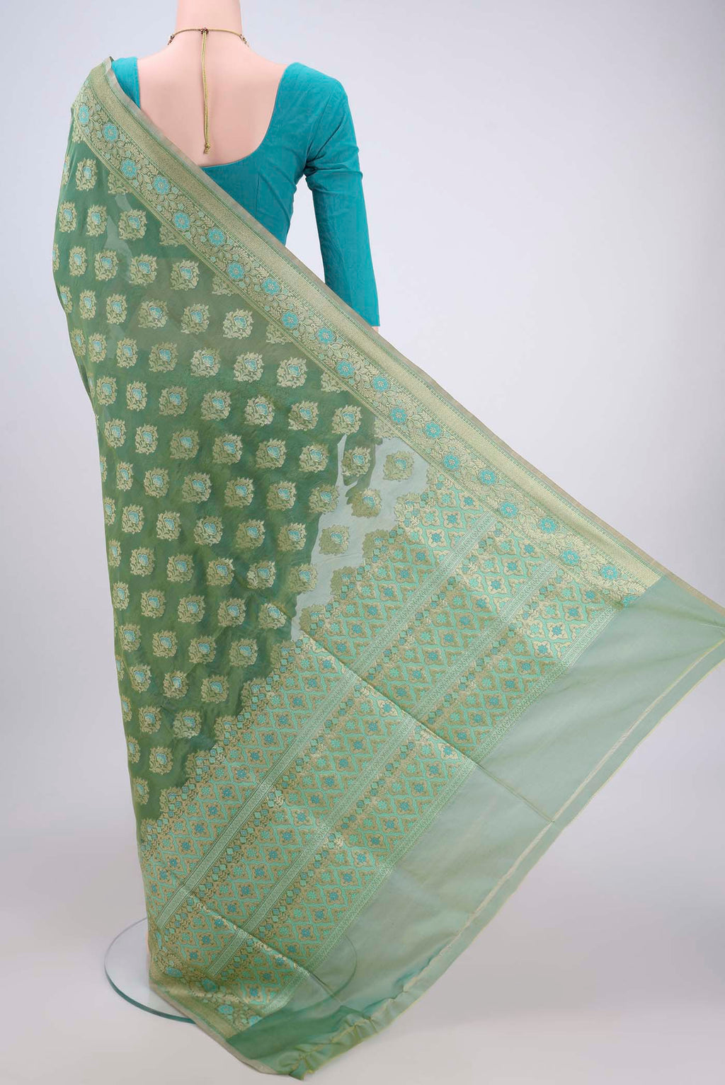Flat view of Mint Green Banarasi Silk Saree with Zari And Thread Butta on the body and Zari Border. 