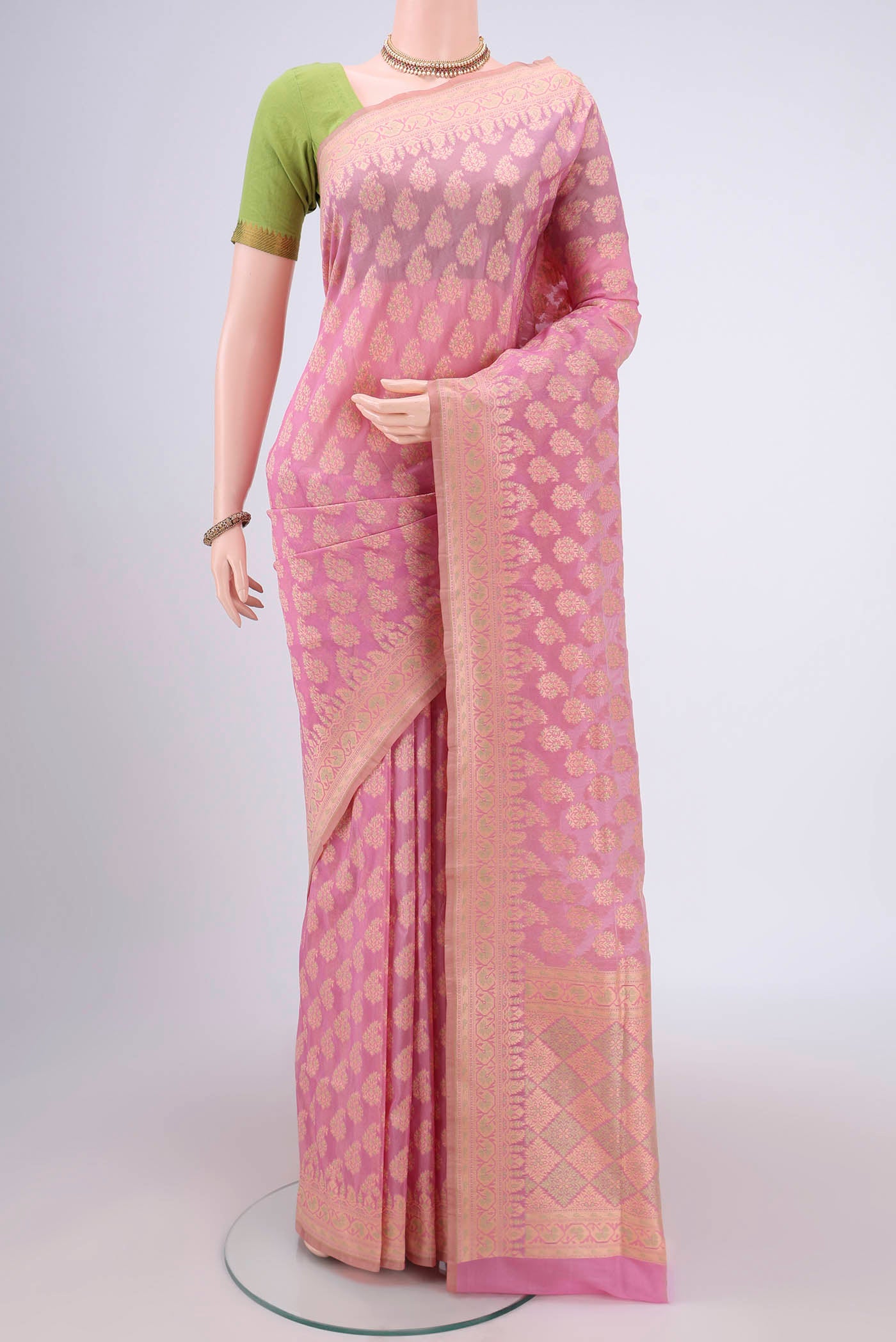 Rose pink Banarasi Silk Saree with Zari And Thread Butta on the body and Zari Border.  displayed on a mannequin