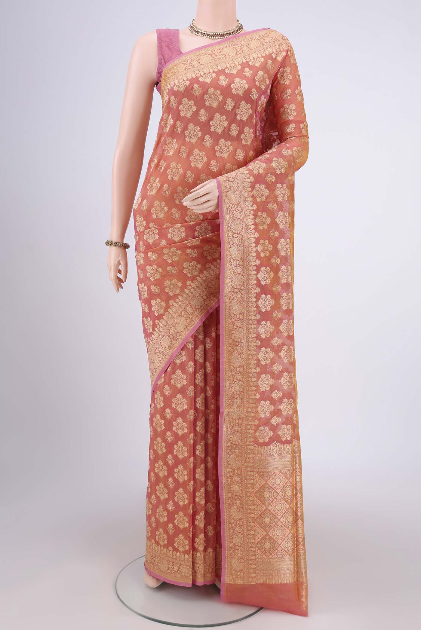 Brick Orange Dual Tone Banarasi Silk Saree with Zari Butta on the body and Zari Border.  displayed on a mannequin