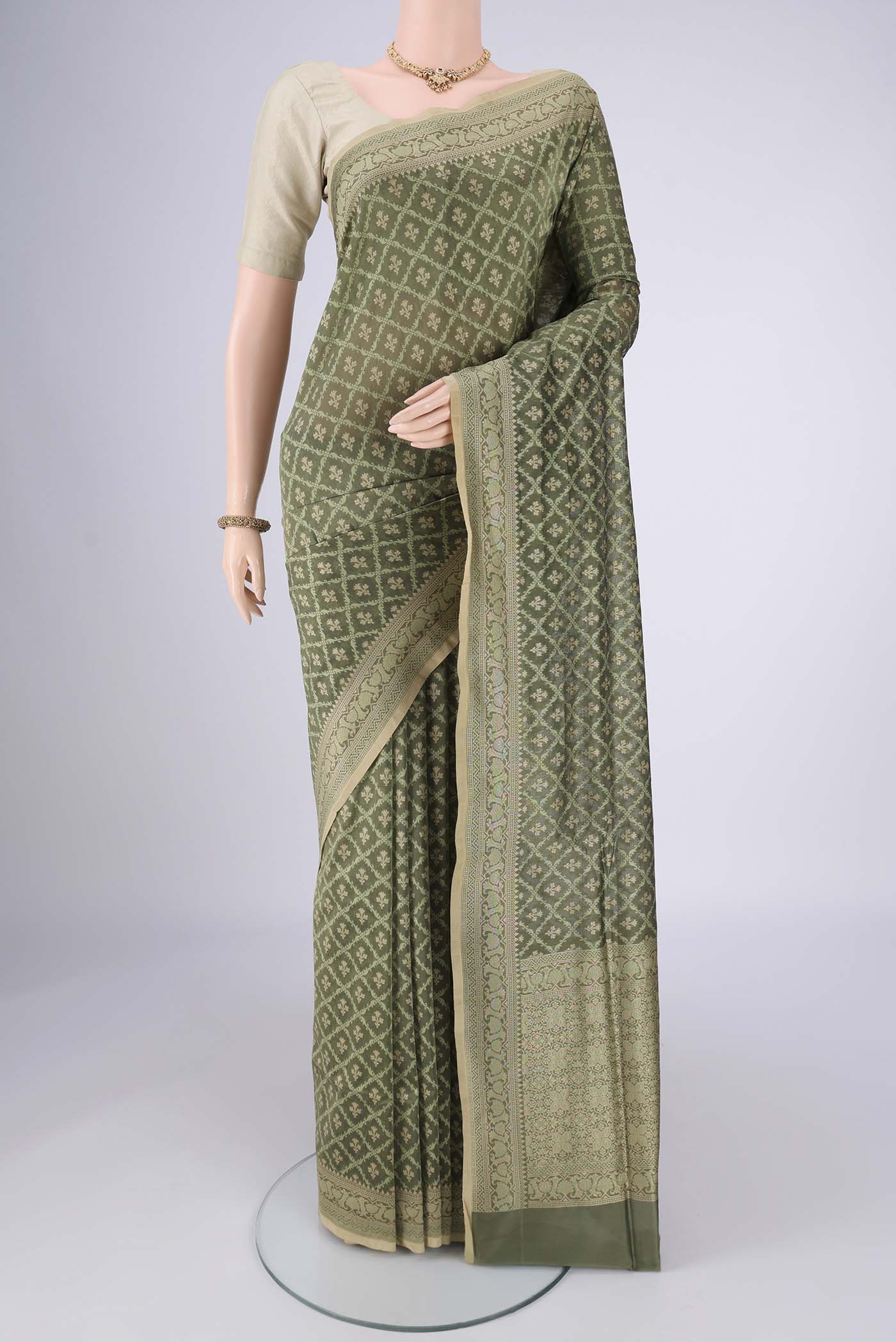 Olive Green Banarasi Silk Saree with Jacquard With Zari Butta on the body and Zari Border.  displayed on a mannequin