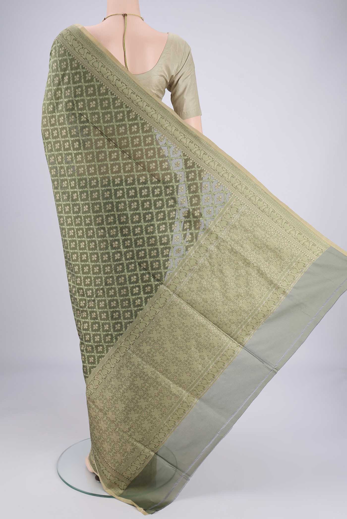 Flat view of Olive Green Banarasi Silk Saree with Jacquard With Zari Butta on the body and Zari Border. 