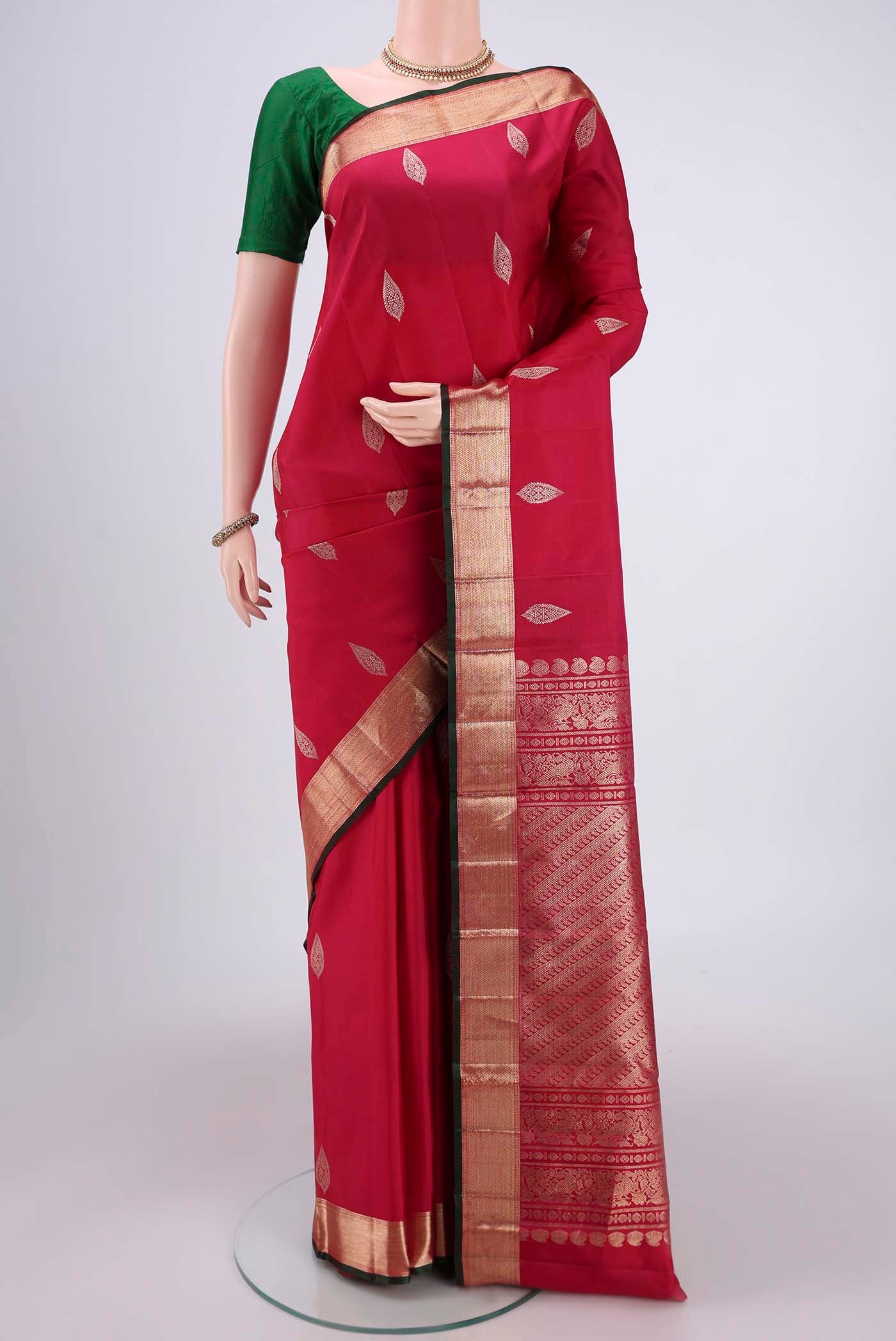 Rani Pink Kanjivaram Silk Saree with Zari Butta on the body and Zari Border.  displayed on a mannequin