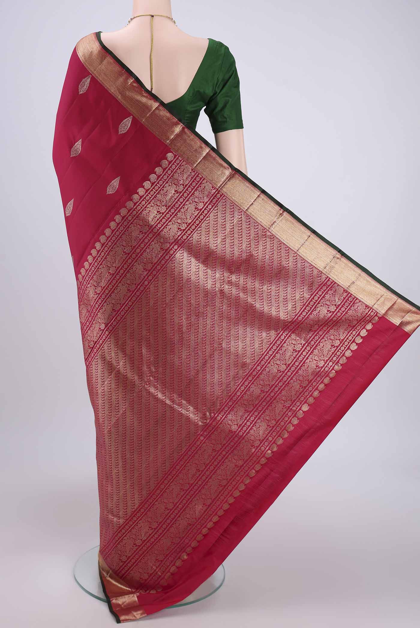 Flat view of Rani Pink Kanjivaram Silk Saree with Zari Butta on the body and Zari Border. 