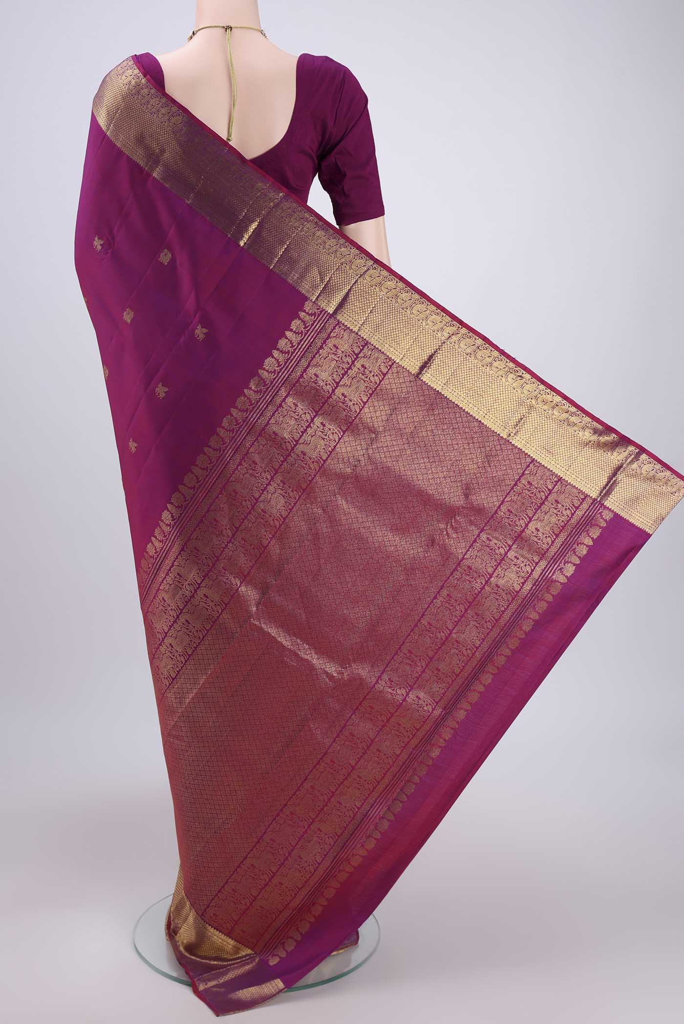 Flat view of Magenta Kanjivaram Silk Saree with Zari Butta on the body and Zari Border. 