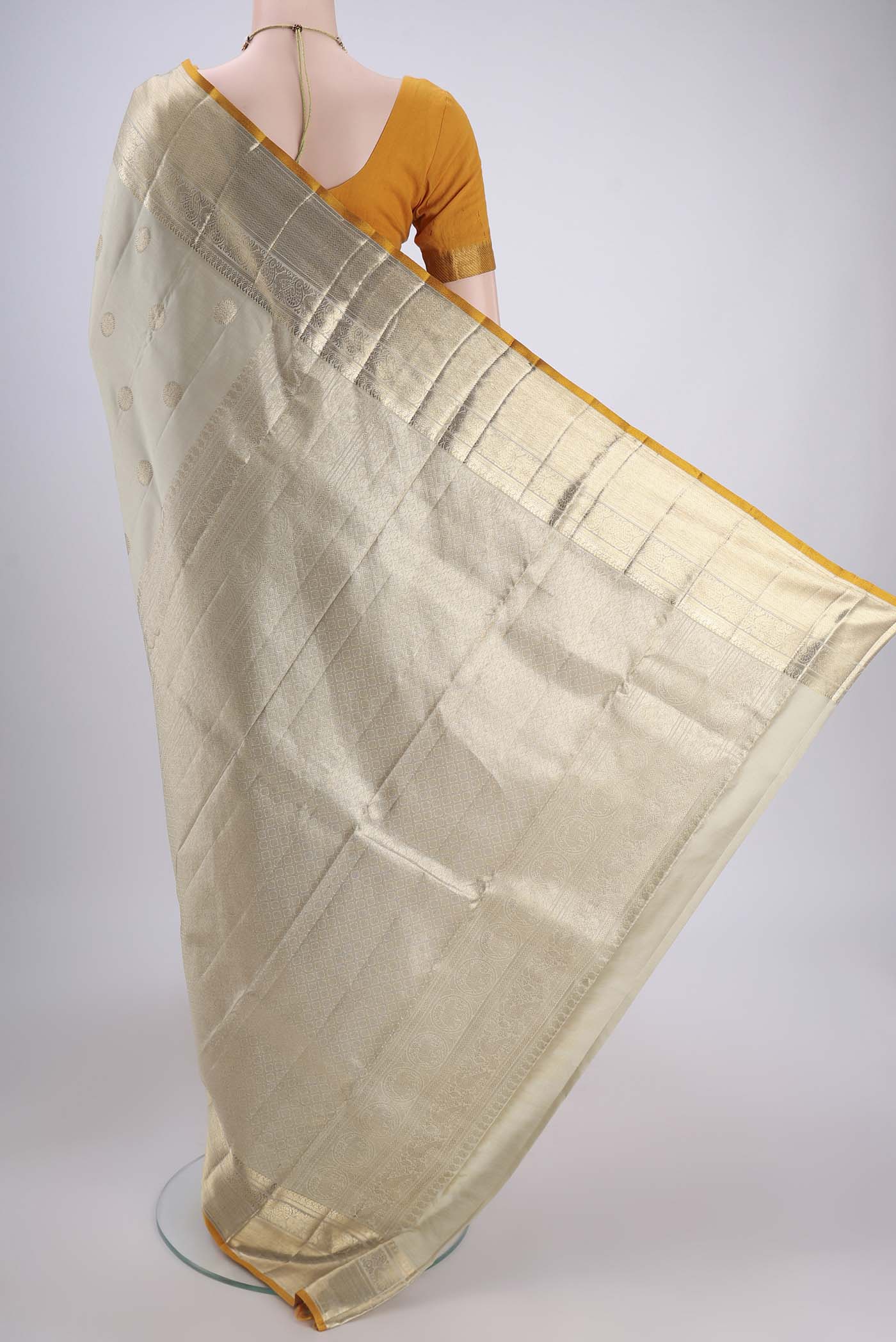 Flat view of Sage Green Kanjivaram Silk Saree with Zari Butta on the body and Zari Border. 