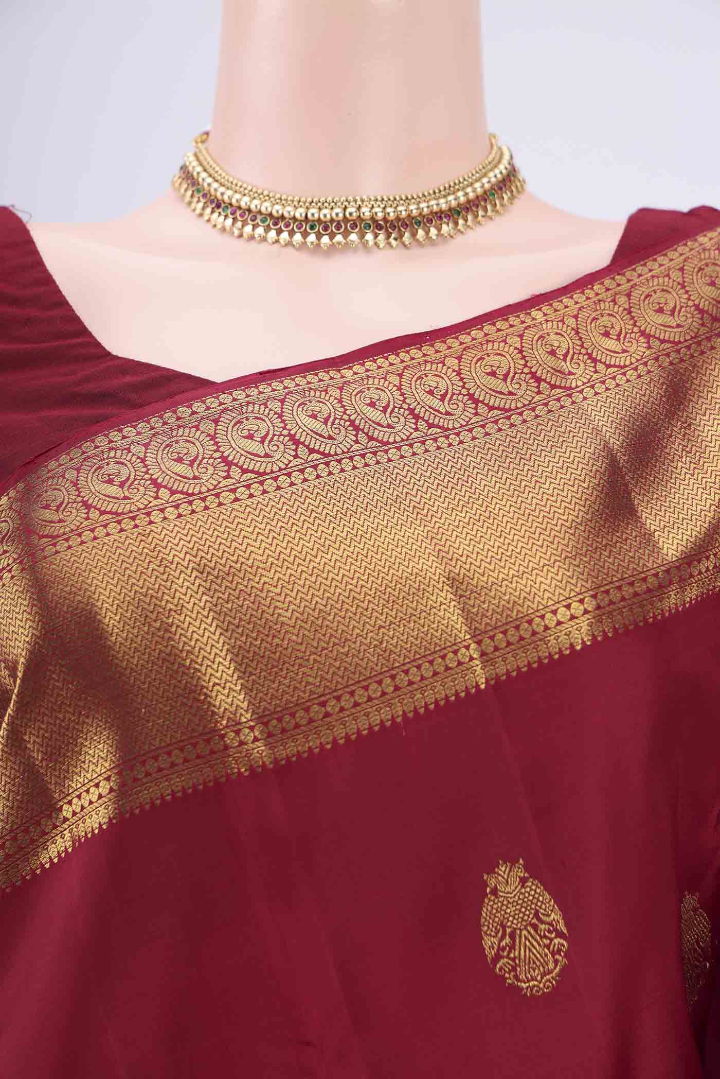 Border image of Maroon Kanjivaram Silk Saree with Zari Butta on the body and Zari Border. 