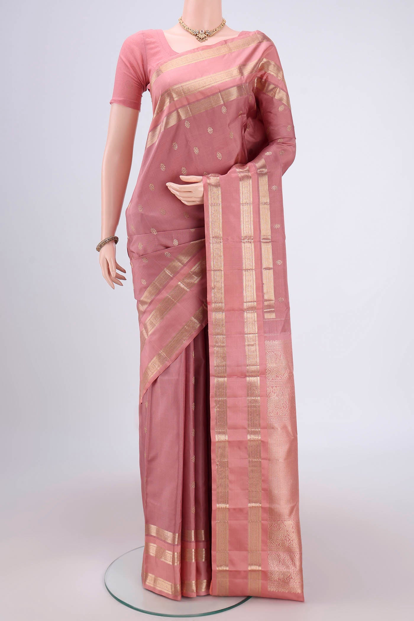 Mauve Kanjivaram Silk Saree with Zari Butta on the body and Zari Border.  displayed on a mannequin